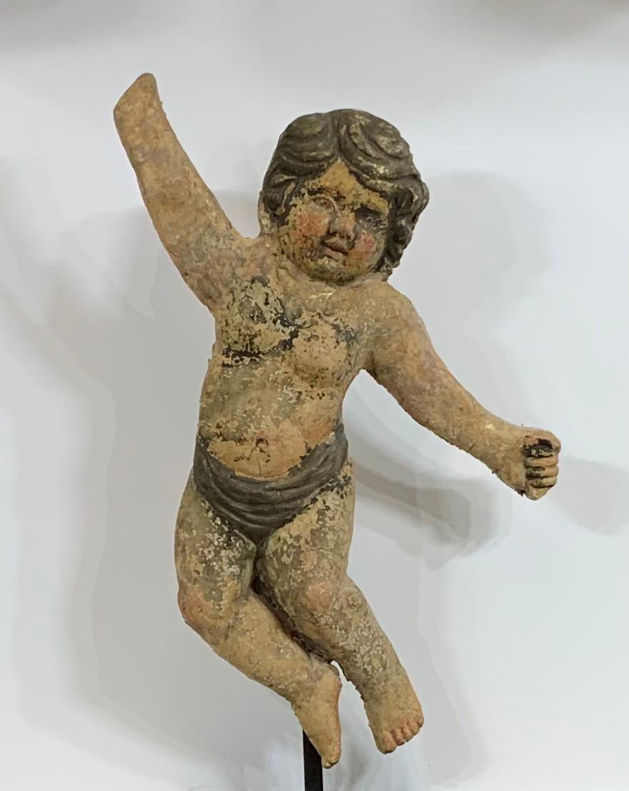 Exceptional antique terra cotta cherub beautifully sculpted by the artist and hand painted. This cherub was salvaged from estate wall in Italy and professionally restored so it is structurally strong to be display on steel custom-made base , or