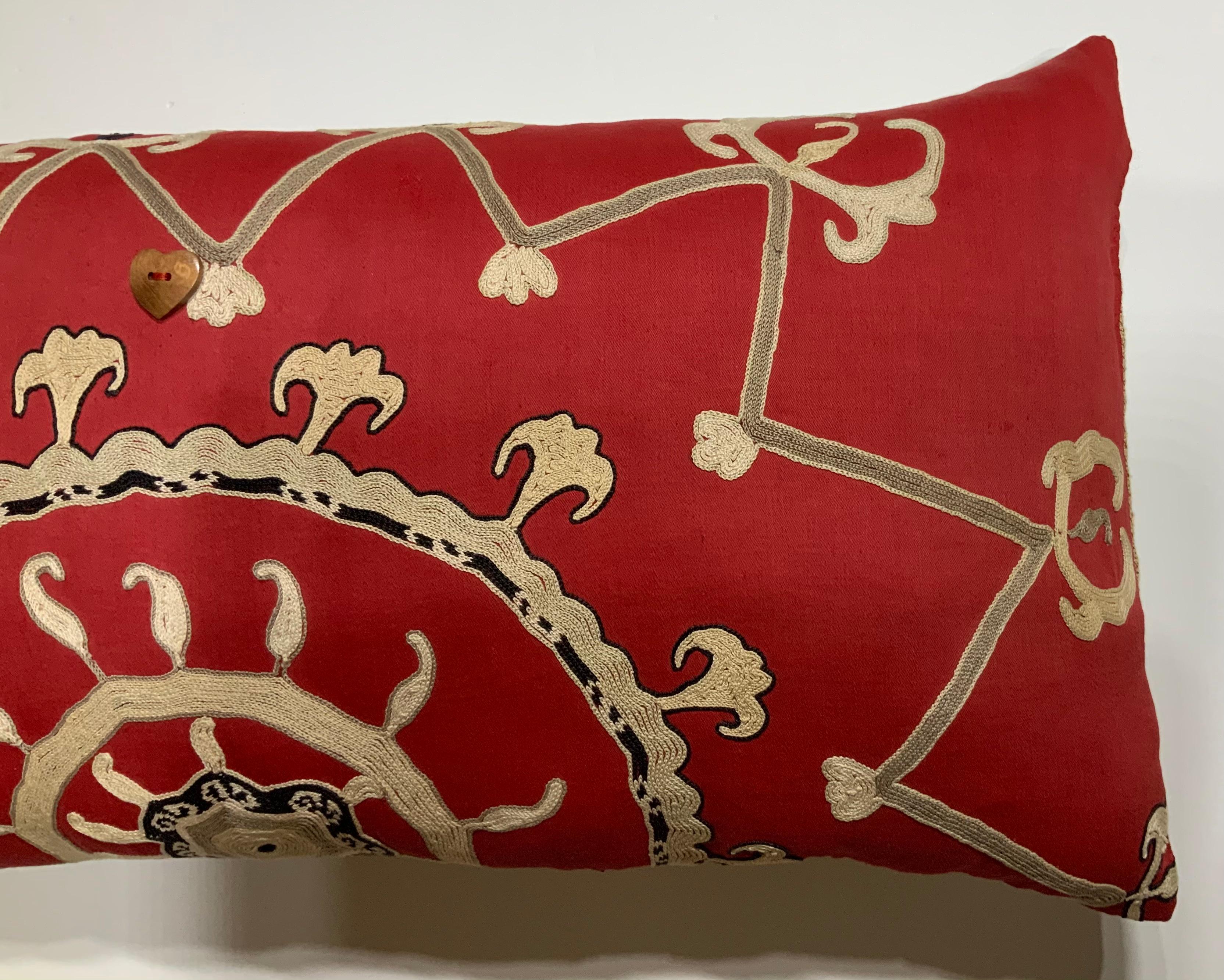 Beautiful pillow made of hand embroidery Suzani textile, with sun and vines embroidery motif on a red cotton background. Great decorative vibrant pillow for any room. Fresh insert, cotton backing.
  