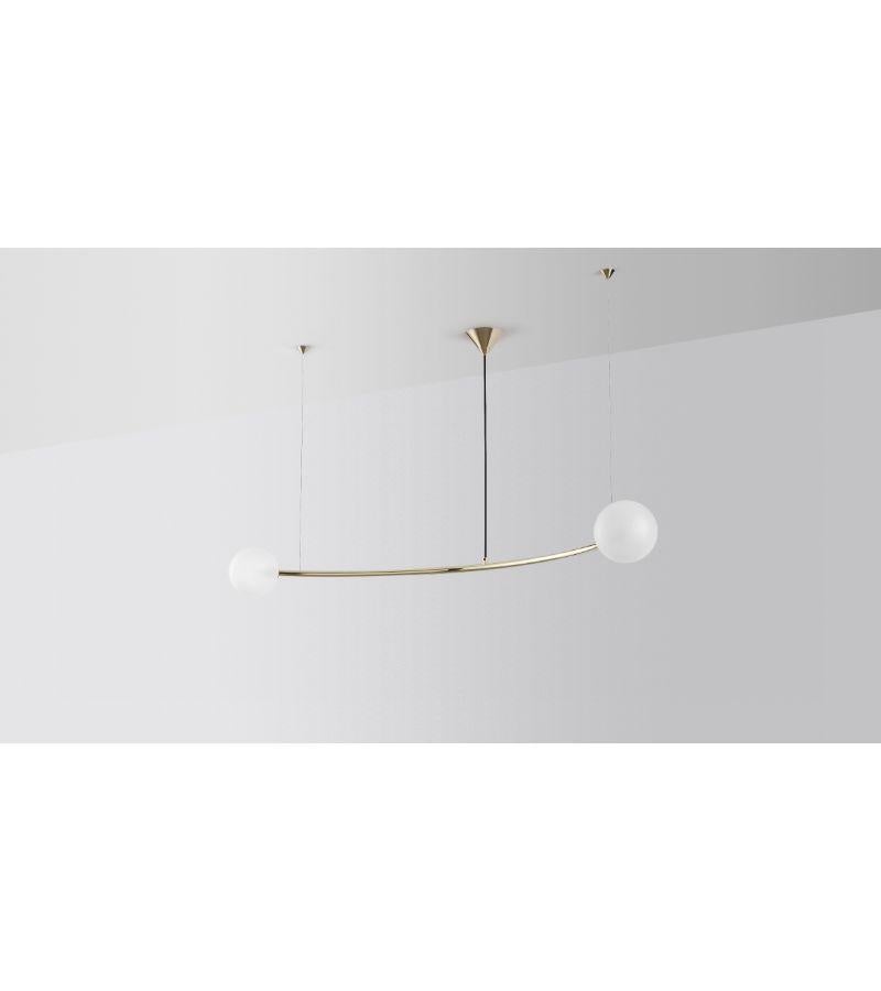 Single arc oddments chandelier by Volker Haug
Dimensions: diameter 110 x height 40 cm 
Material: brass. 
Finish: polished, aged, brushed, bronzed, blackened, or plated
Cord: black fabric
Light: : G9 LED (110V - 240V) or G4 LED (12V)
Glass