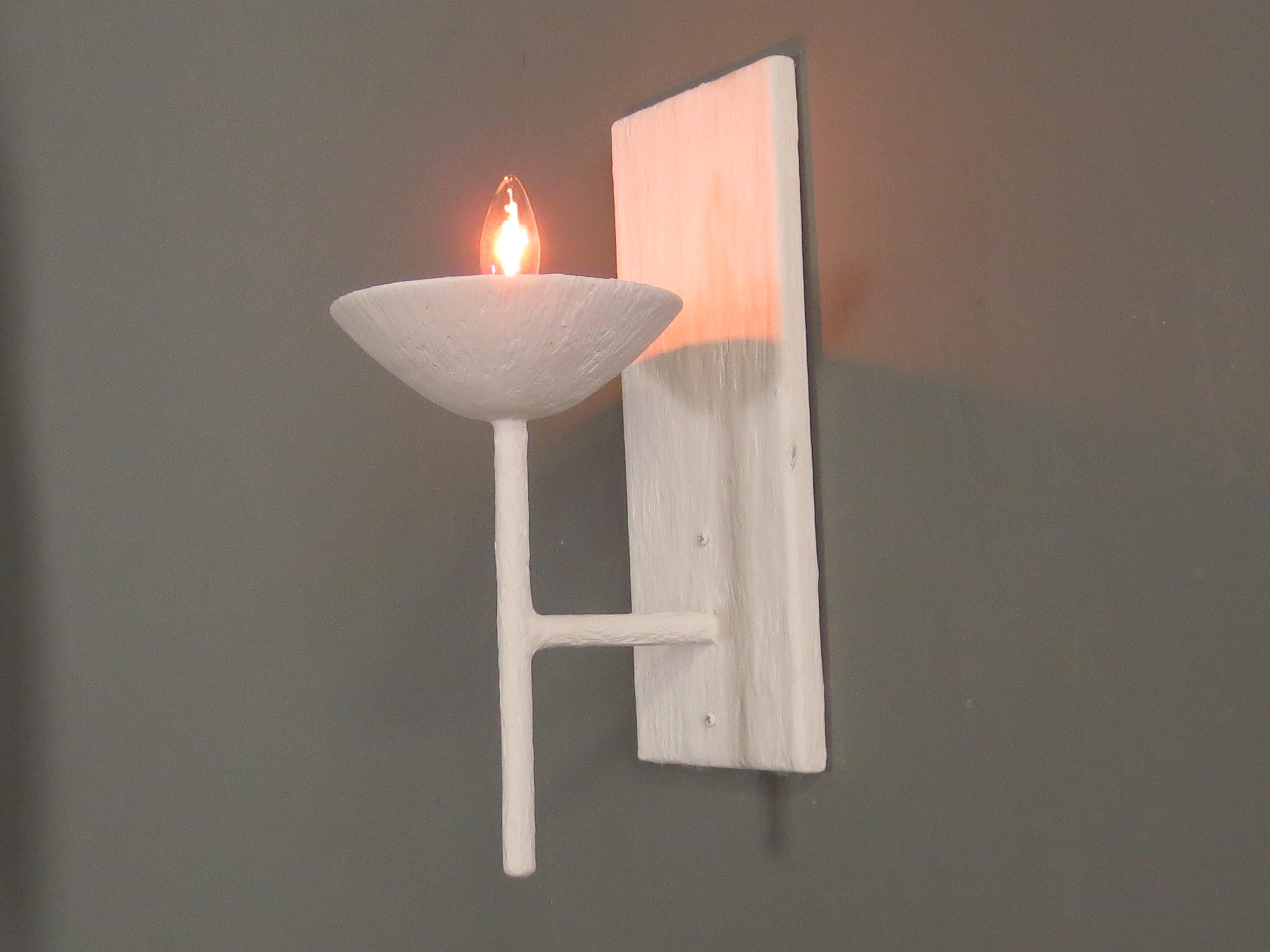 Single arm plaster sconce by Tracey Garet of Apsara Interior Design. The Sconce has a single 6