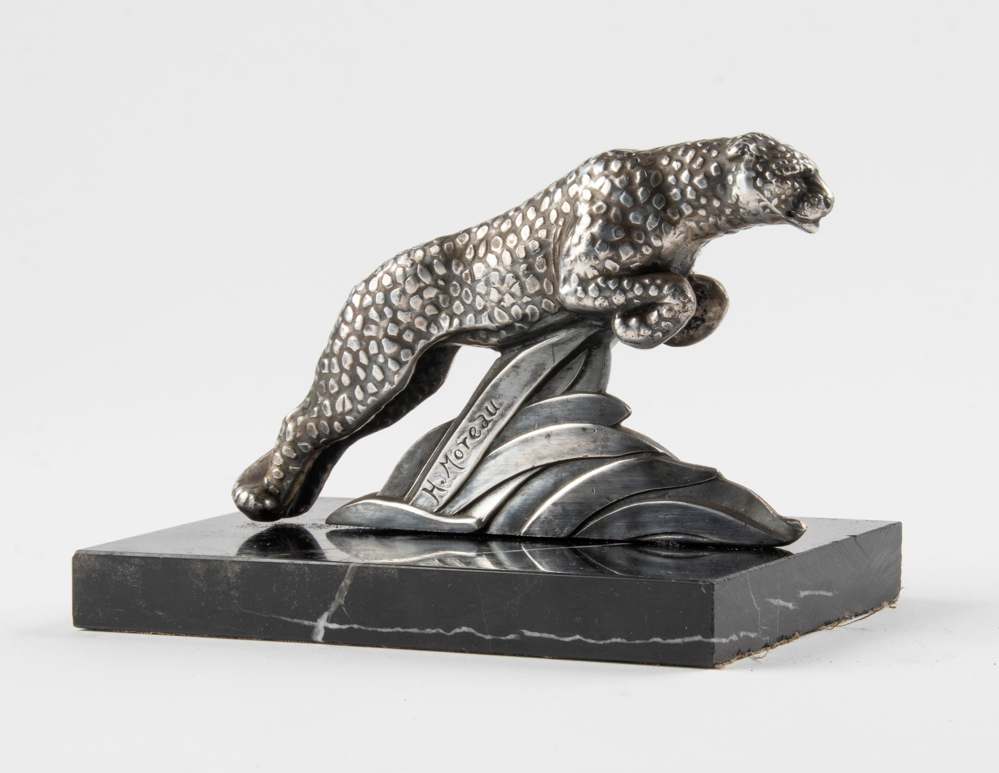 Stylish single Art Deco Book end with a spelter sculpture of a leopard. The figurine is patinated in a silver color and stands on a black marble base. Signed 'H. Moreau'.