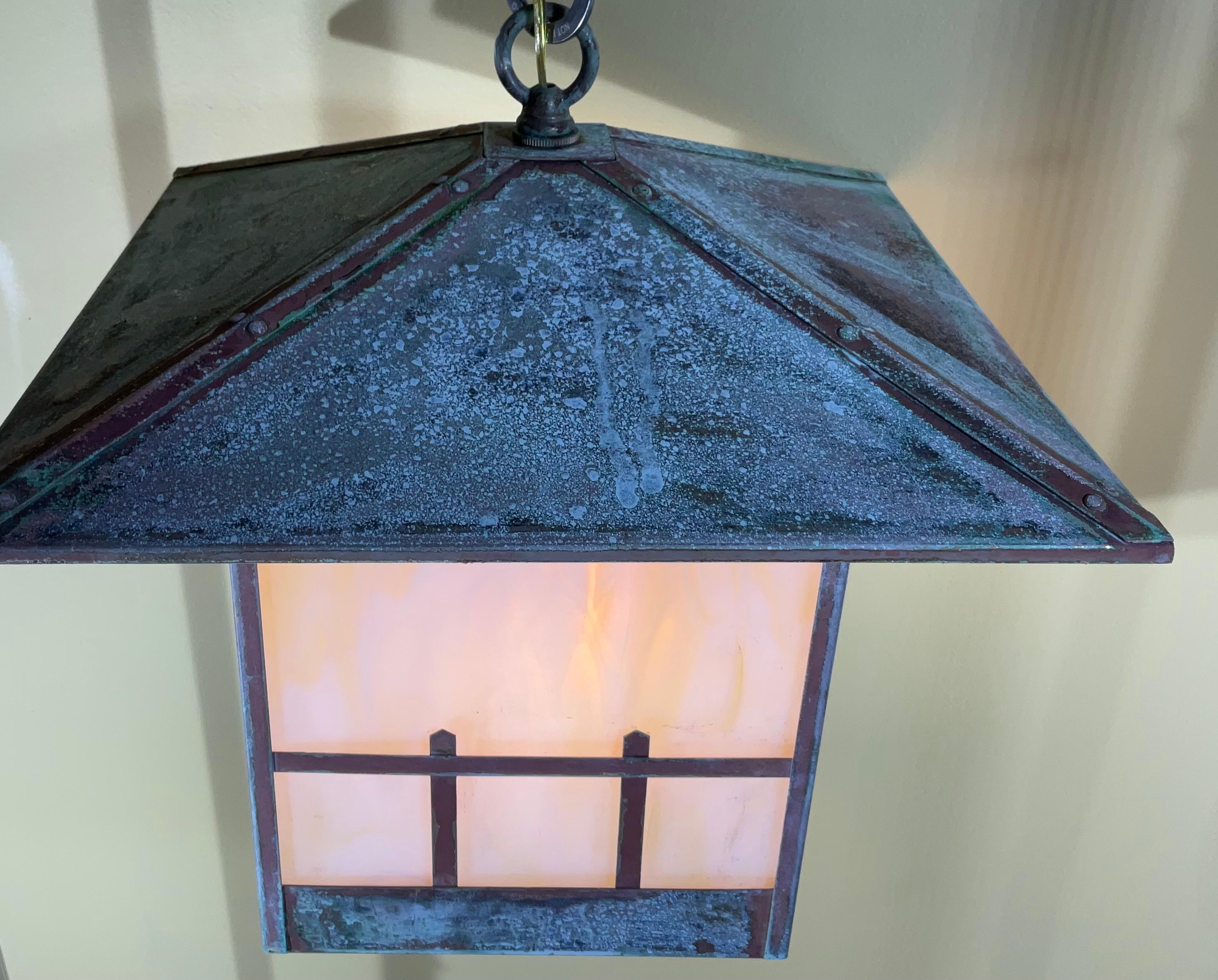  20th century Arts & Crafts pendant light ,Features   beautiful art glass shades , newly wired with new porcelain socket .  nice patina.
Canopy is not included.
One more available on line .