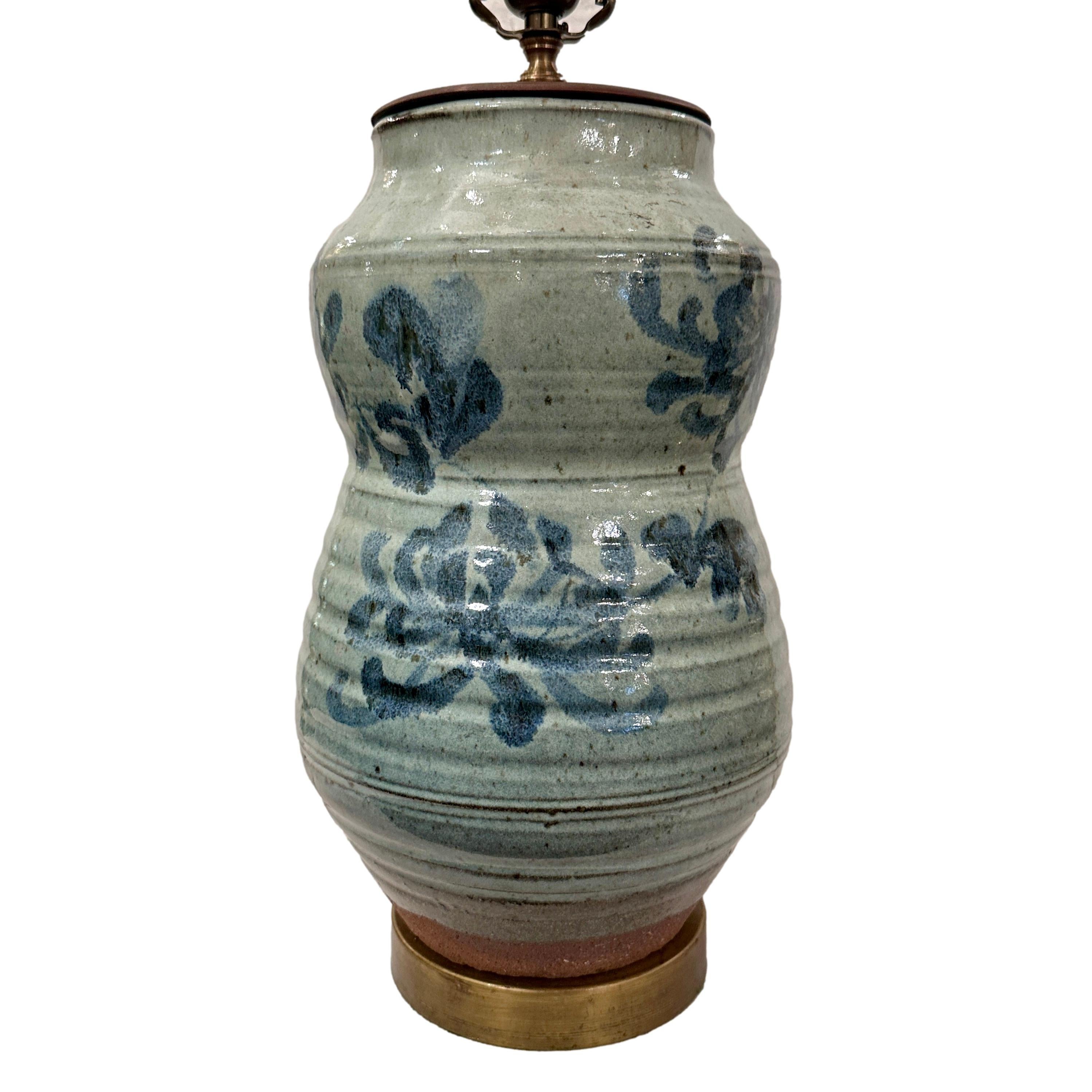 A circa 1950's Italian blue ceramic lamp with floral motif.

Measurements:
Height of body: 16