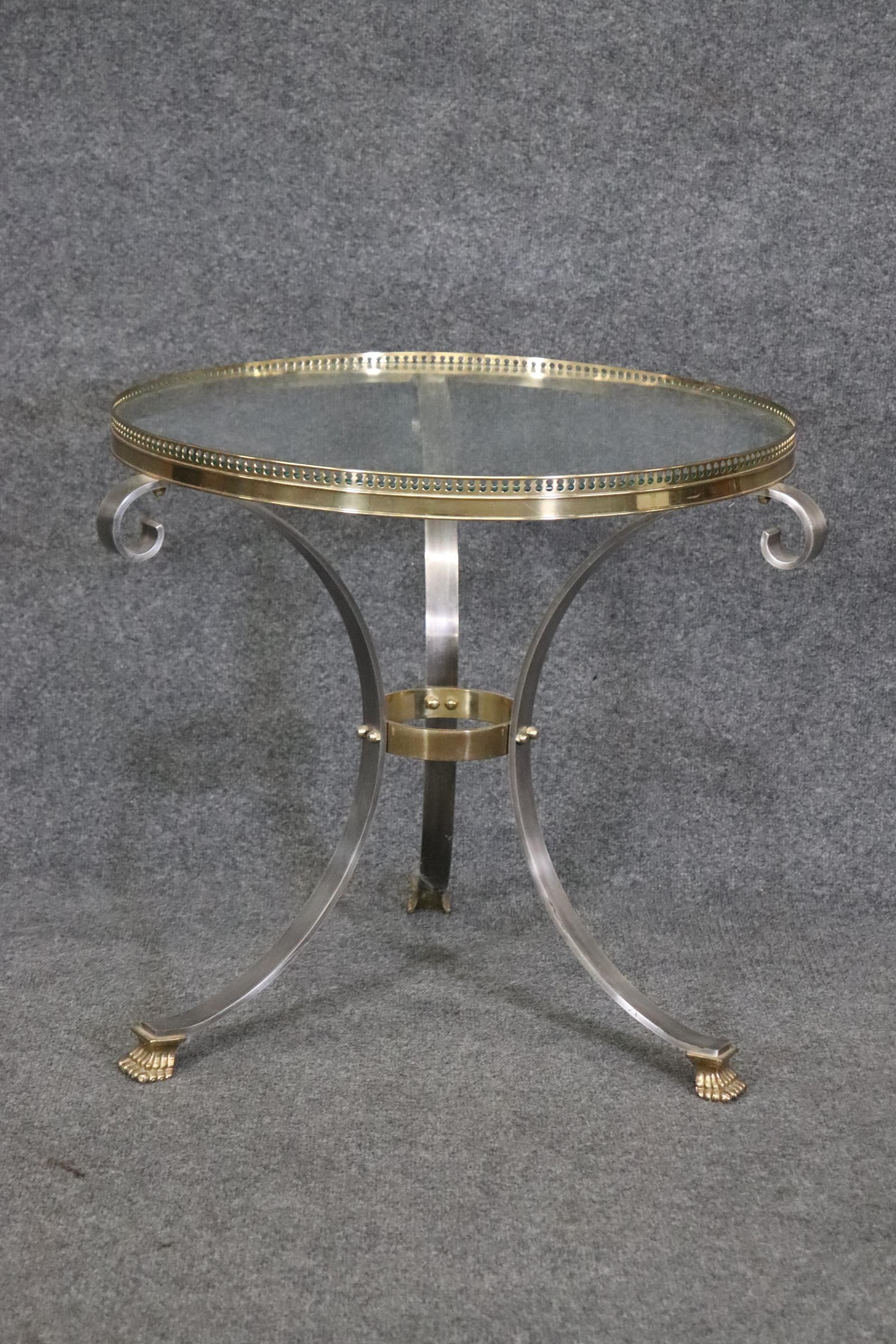 This is a gorgeous brass and steel high quality Maison Jansen style gueridon or end table. The table is in the Directoire style and is in good condition and measures 25.5 wide x 25.5 deep x 22.5 tall. The table dates to the 1990s. 