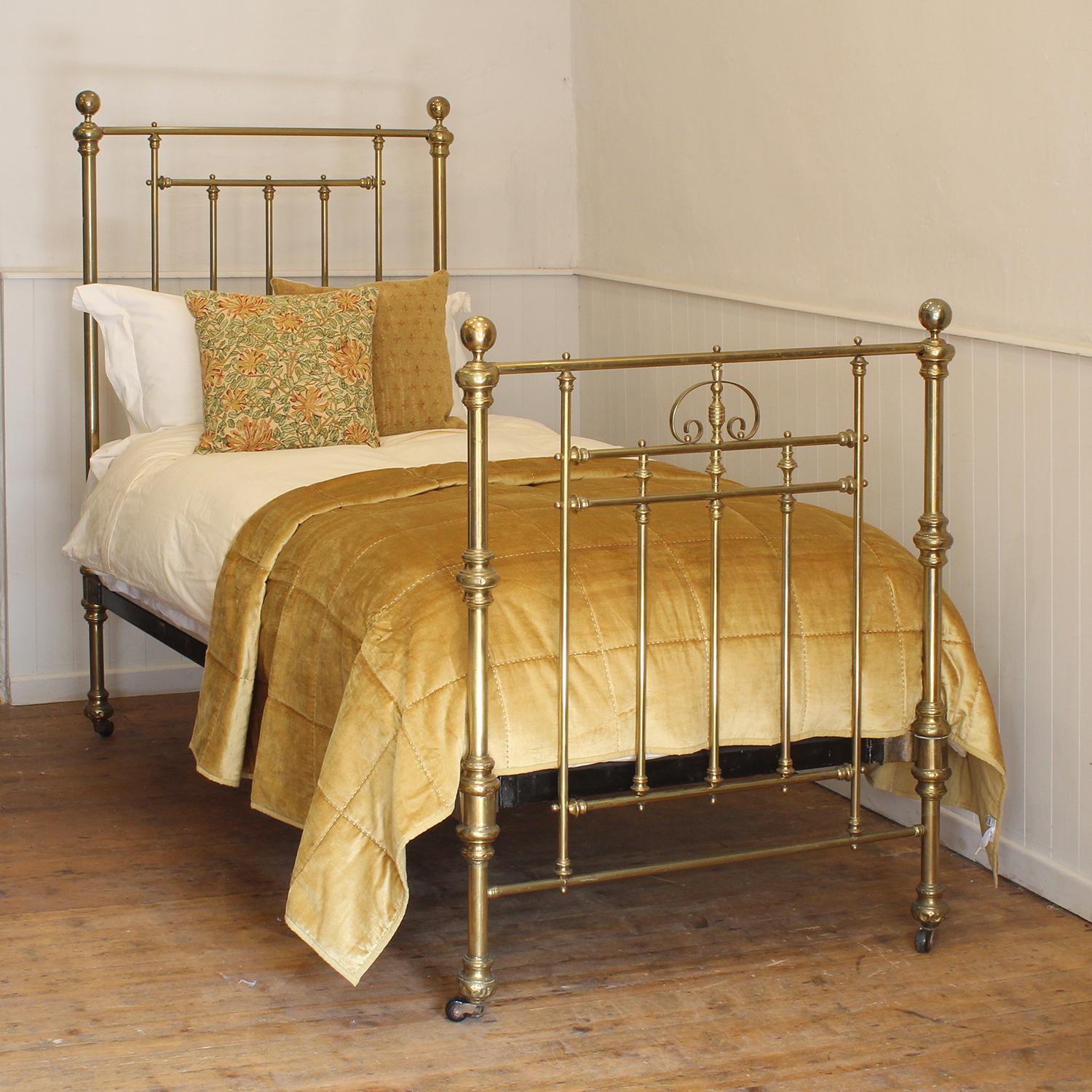 A traditional brass and iron Victorian single bed with fine patina and decorative foot board.
This bed takes a standard UK single 3ft wide x 6ft 3in long base and mattress, but will take a US twin 38 inch wide base and mattress with a slight
