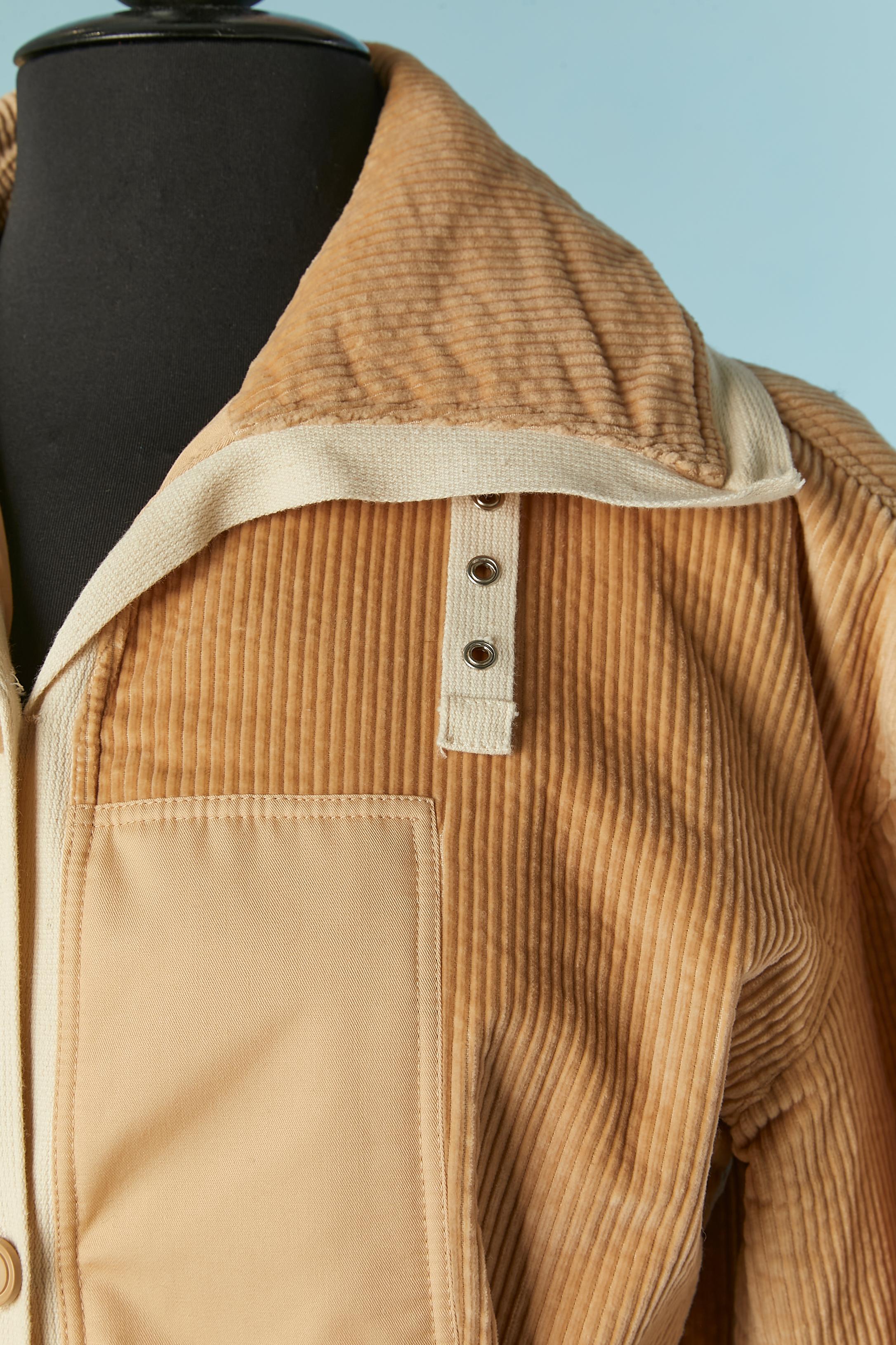 Single-breasted beige cotton and Corduroy coat. Acetate lining. 
Half-belt in cotton with button and buttonhole in the front and adjustable buckle in the middle back; Half-belt with buckle and eyelet around the collar. Pockets on both side. 
SIZE