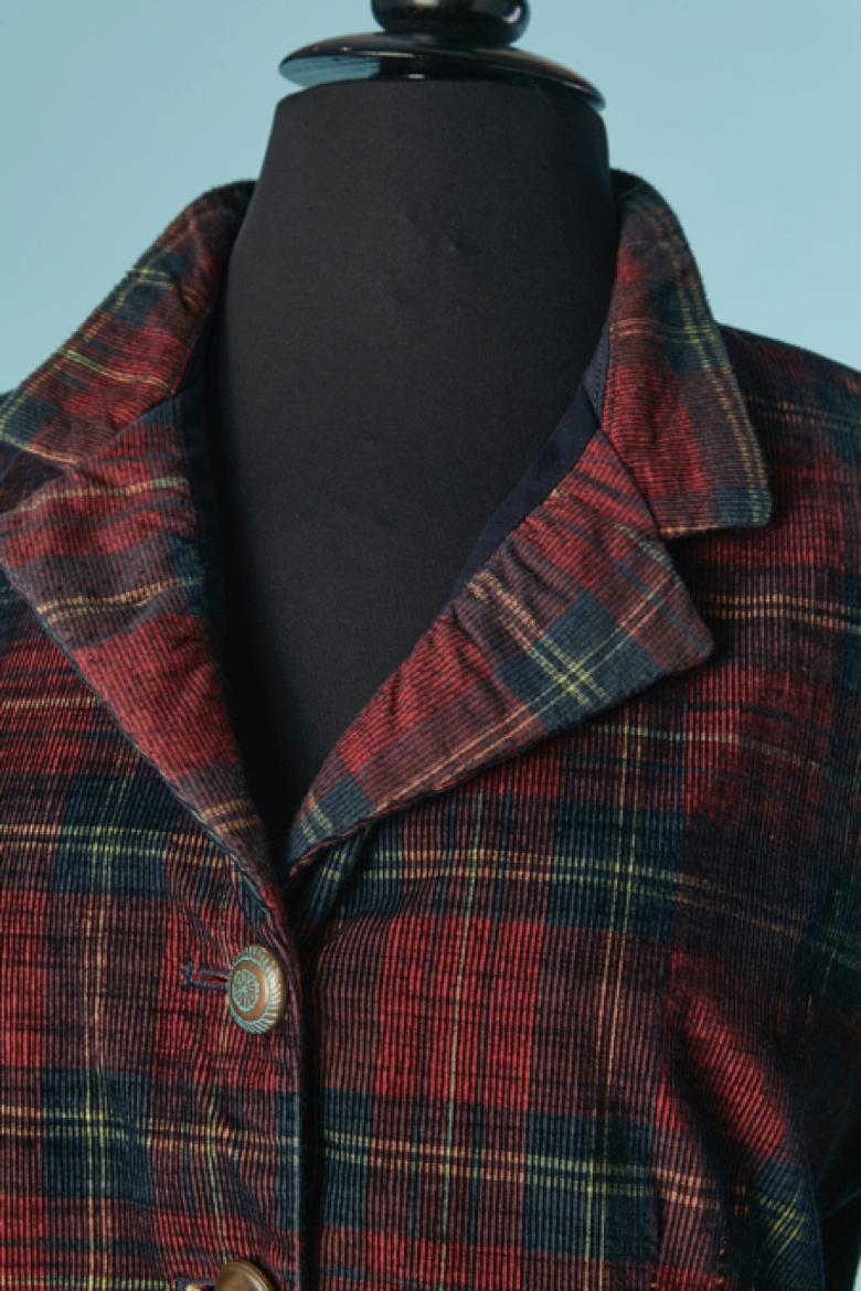 Single breasted Corduroy (100% cotton) jacket with Tartan pattern. Lining composition: 51% polyester, 49% acetate. Trompe l'oeil shirt sleeve on the bottom edge of the jacket sleeves. Mix and match button and buttonhole closure on the middle front.