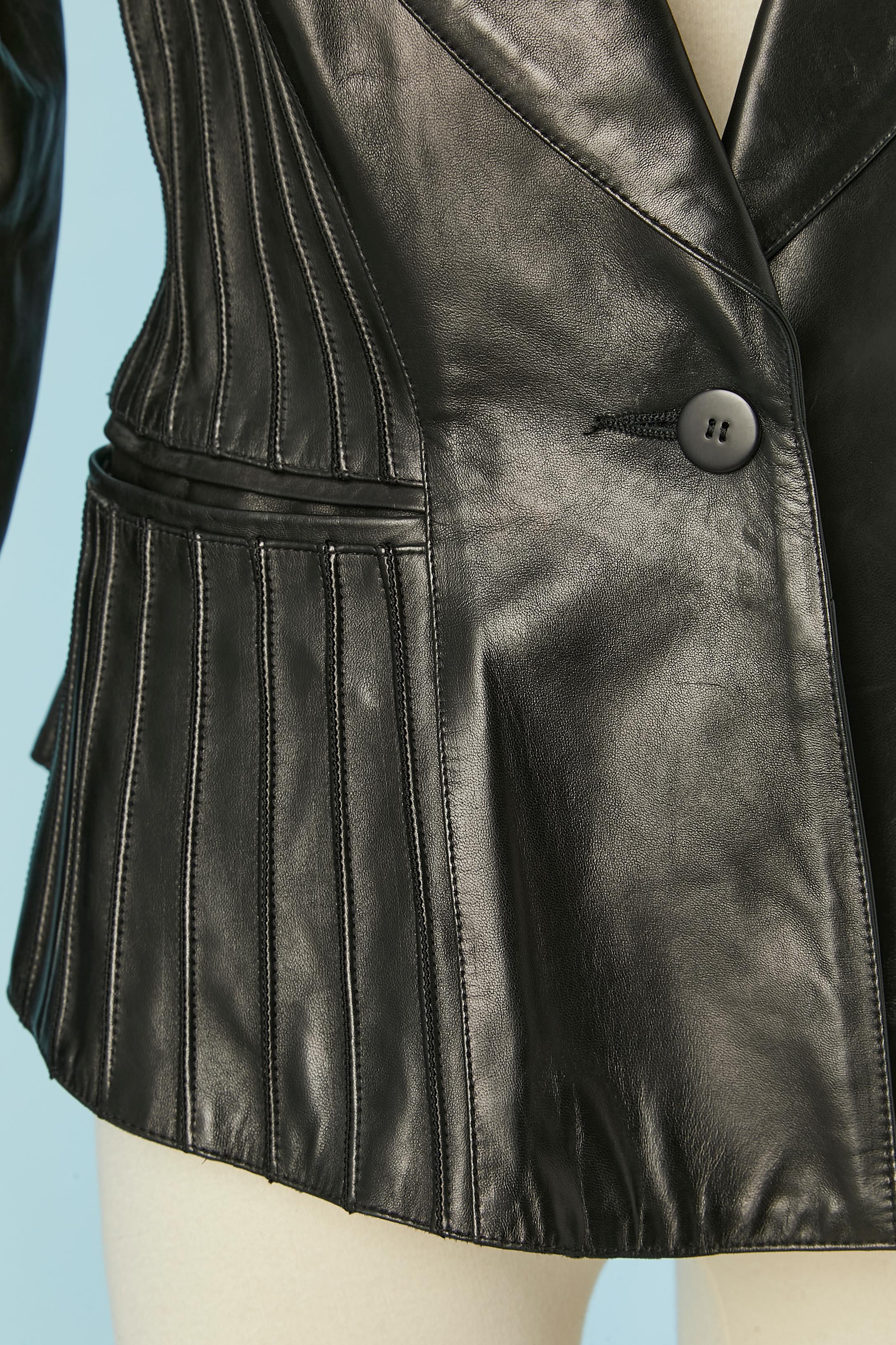 Black leather single breasted jacket with top-stitching. Acetate lining. Button and buttonhole closure. Shoulder-pad. Pocket on both side. 
SIZE 38 (Fr) 8 (US ) M 