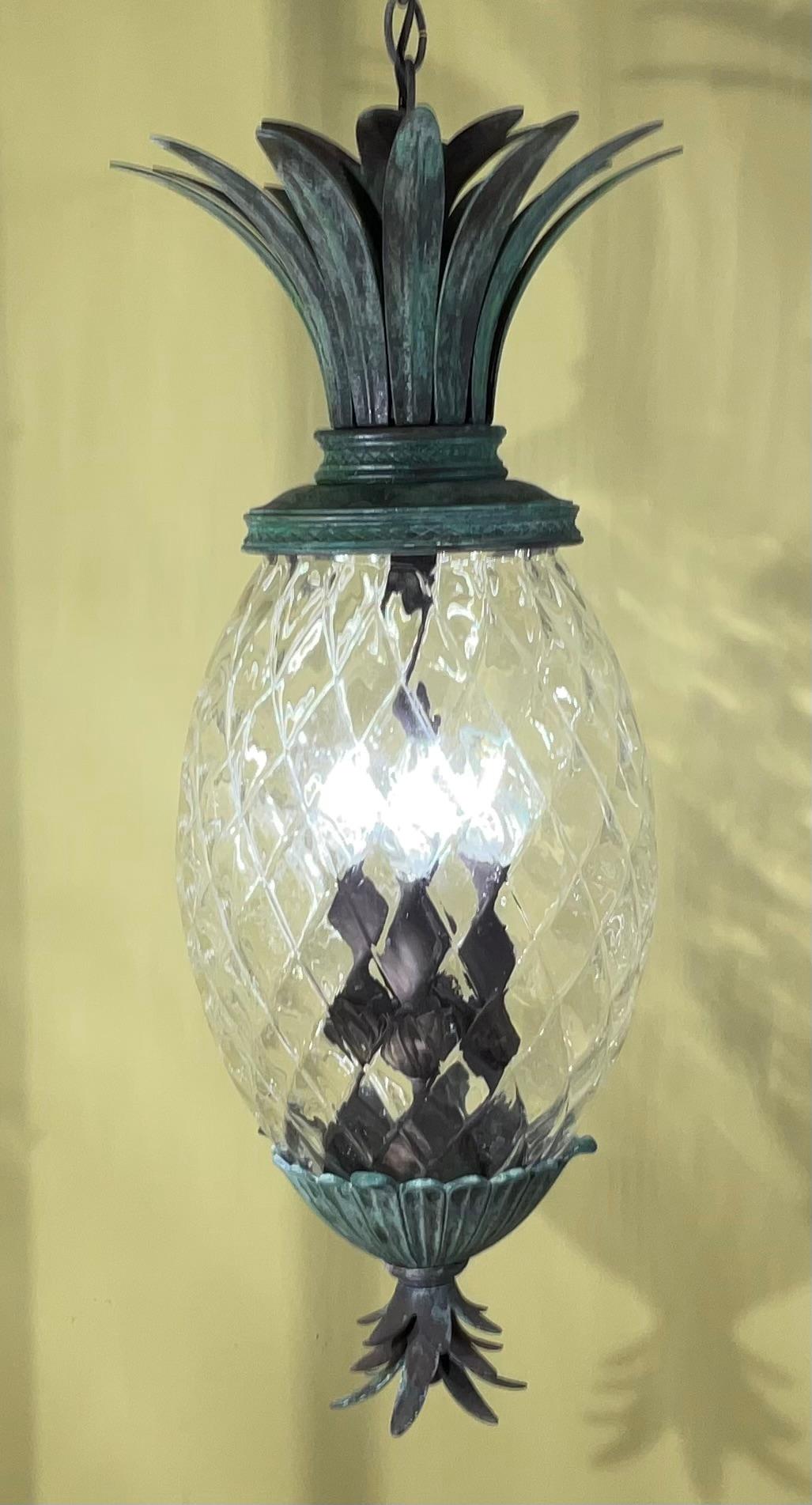 Beautiful single pineapple hanging light , made of bronze and solid brass with four  60/watt light great patina , decorative for indoor or outdoor.
Ready to use.
Original canopy included.