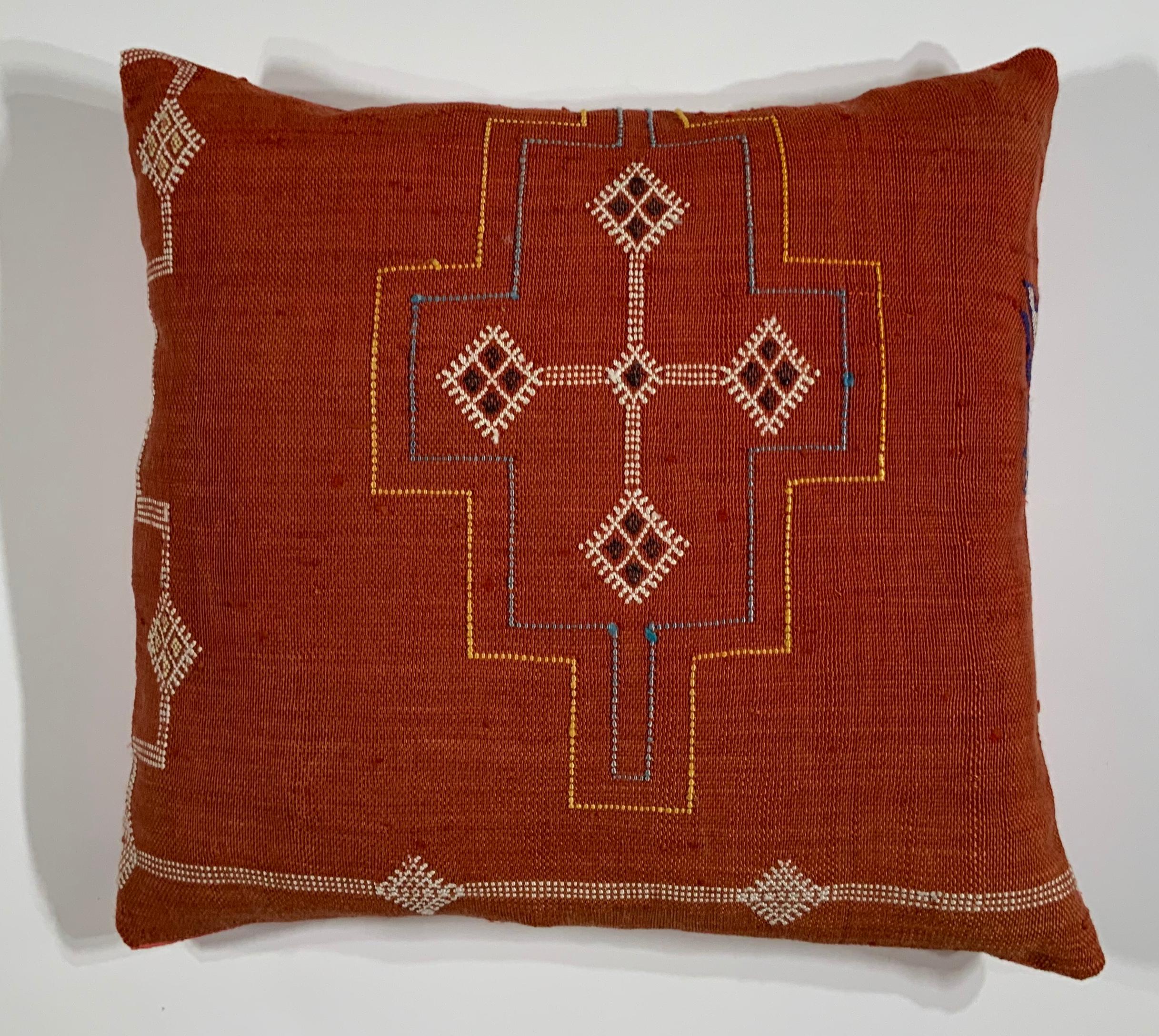Beautiful pillow made of handwoven flat-weave textile with multi colors geometric motifs on a red background, fine silk backing, fresh new insert.