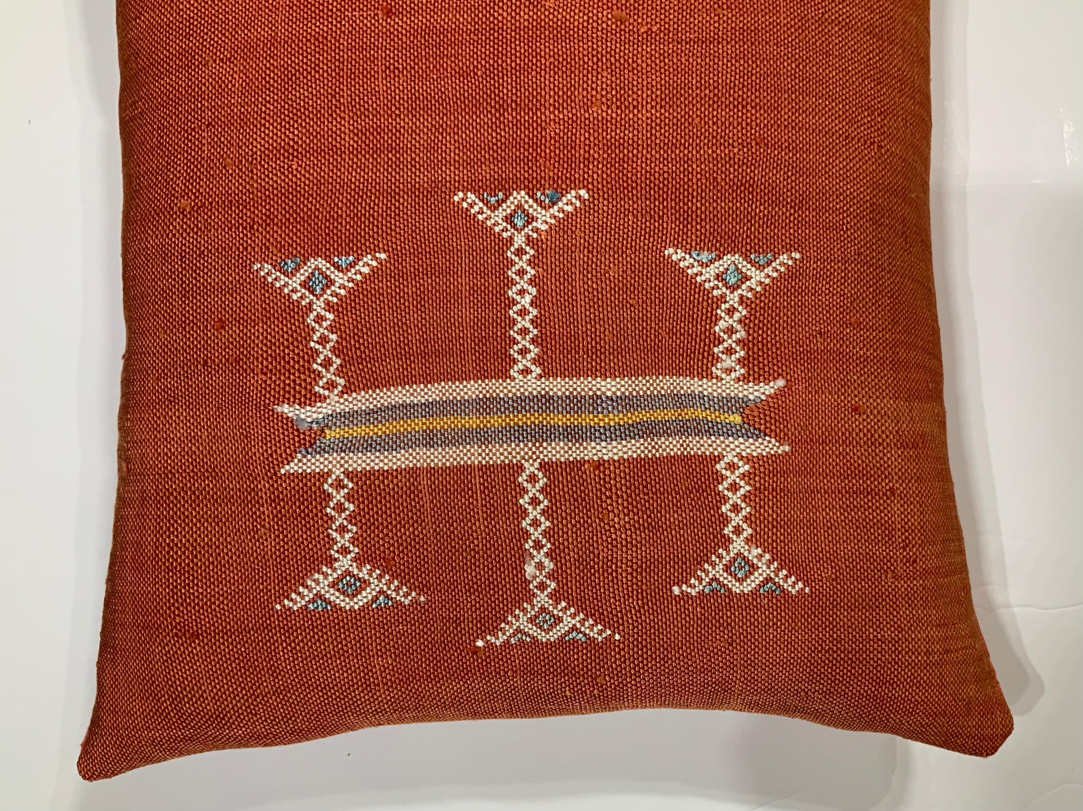 Beautiful pillow made of handwoven flat-weave textile with multi colors geometric motifs on a red background, fine silk backing, fresh new insert.