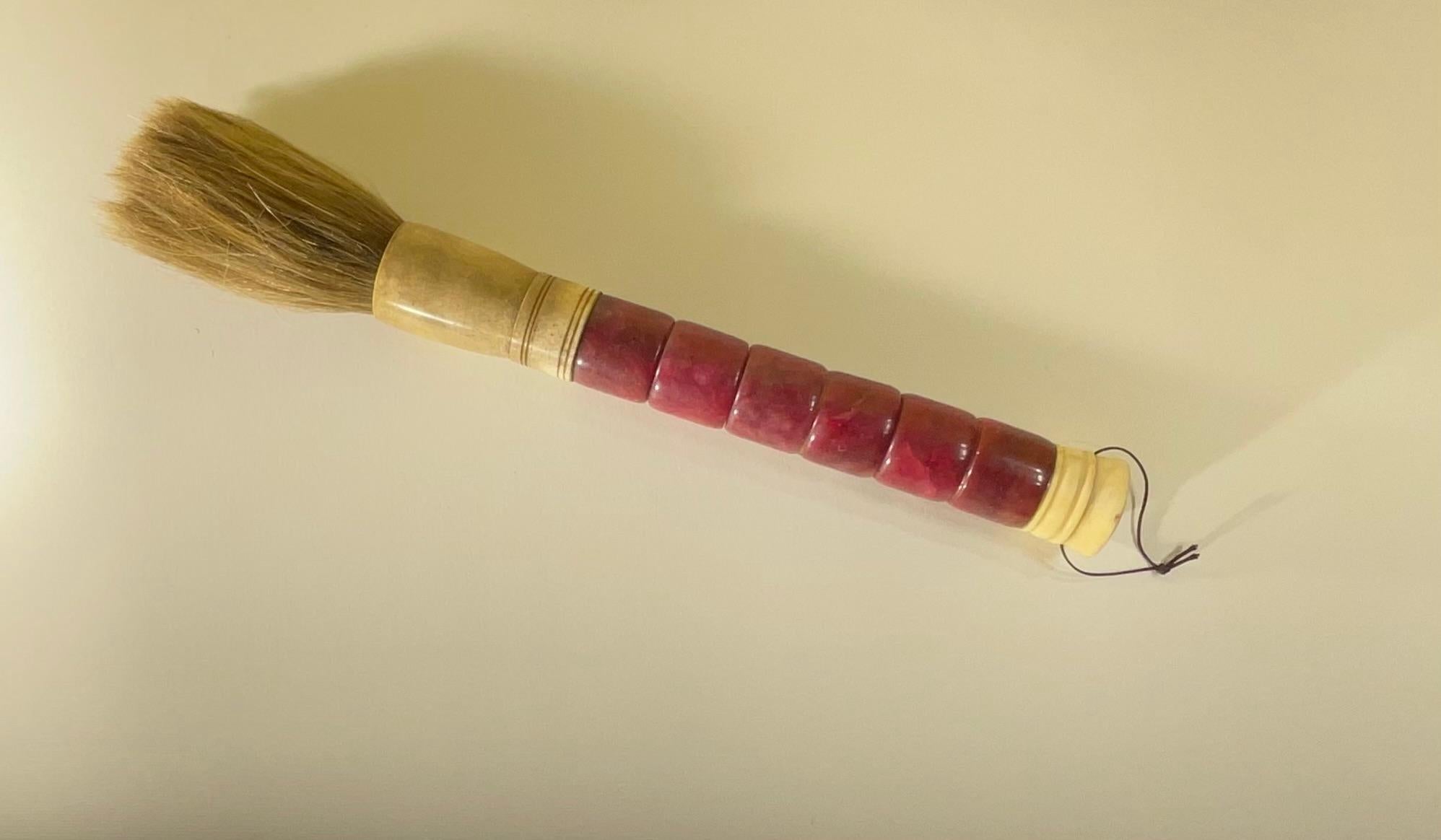Beautiful single hand made calligraphy brush with exceptional wine color marble beads ,bone , ferrule and horse hair. 
 Slight variation in each bead due to characteristics of genuine stone and bone.



