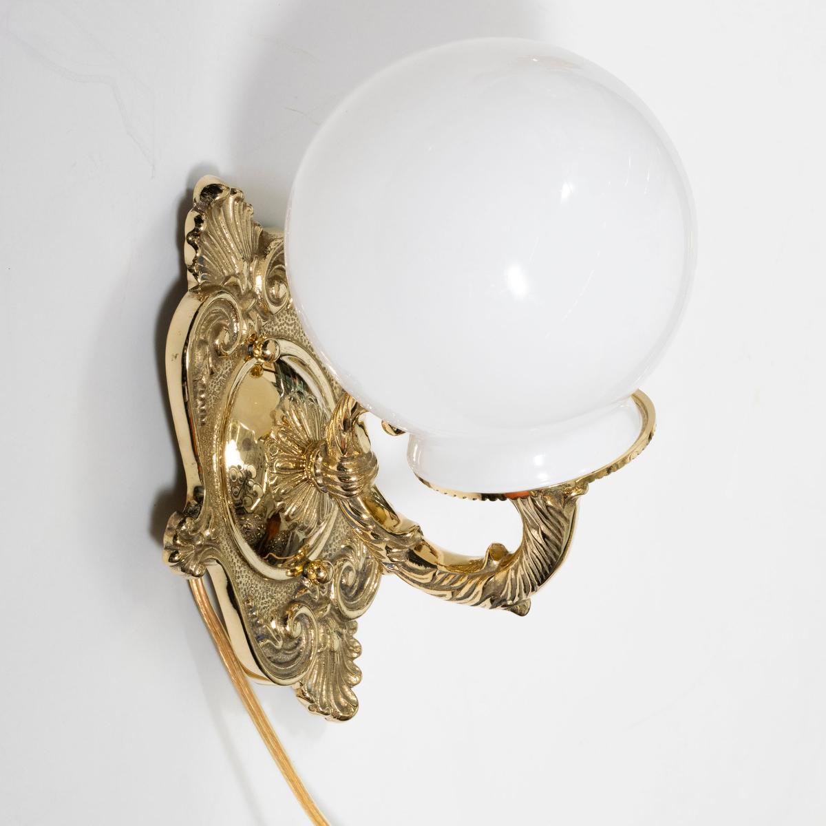 Brass Single cast brass sconce with globe shade For Sale