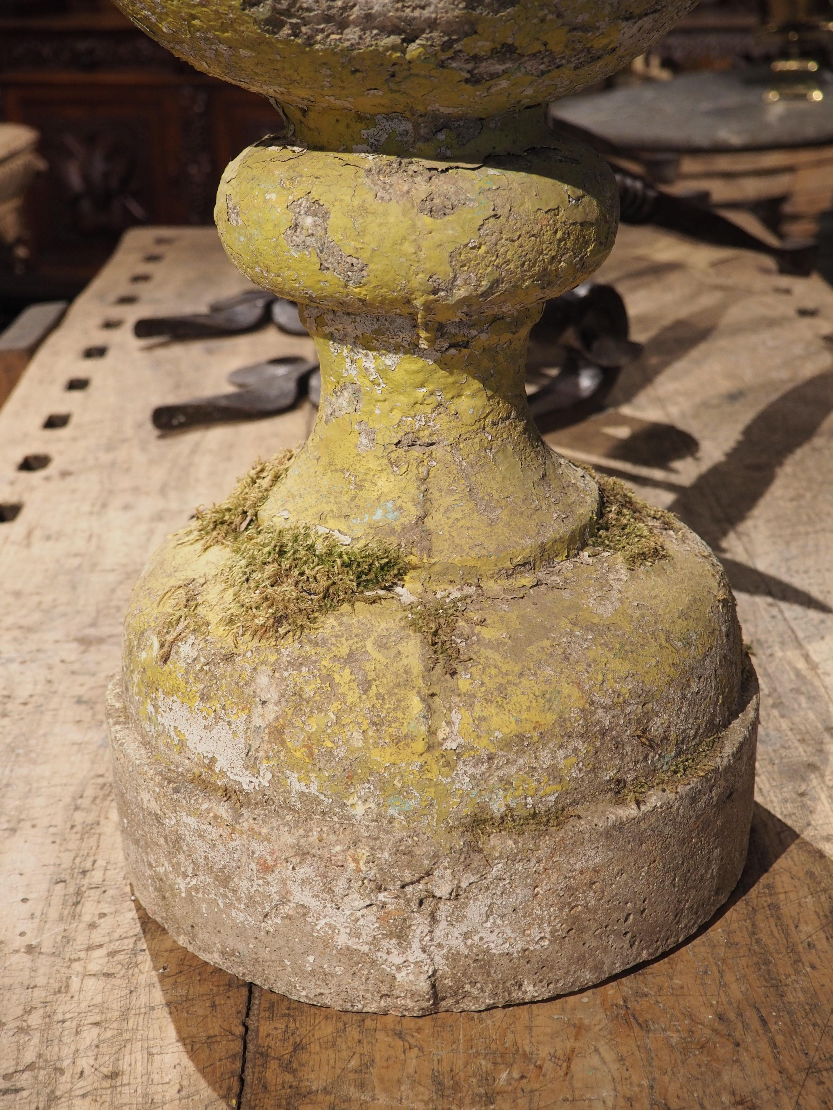 Made from reconstituted stone, this ball finial garden post at nearly 26 inches tall, was cast from a single mold in France in the 1900’s. A 12-inch spherical finial sits on top of a bulbous column. The column has a circular base which sits atop a