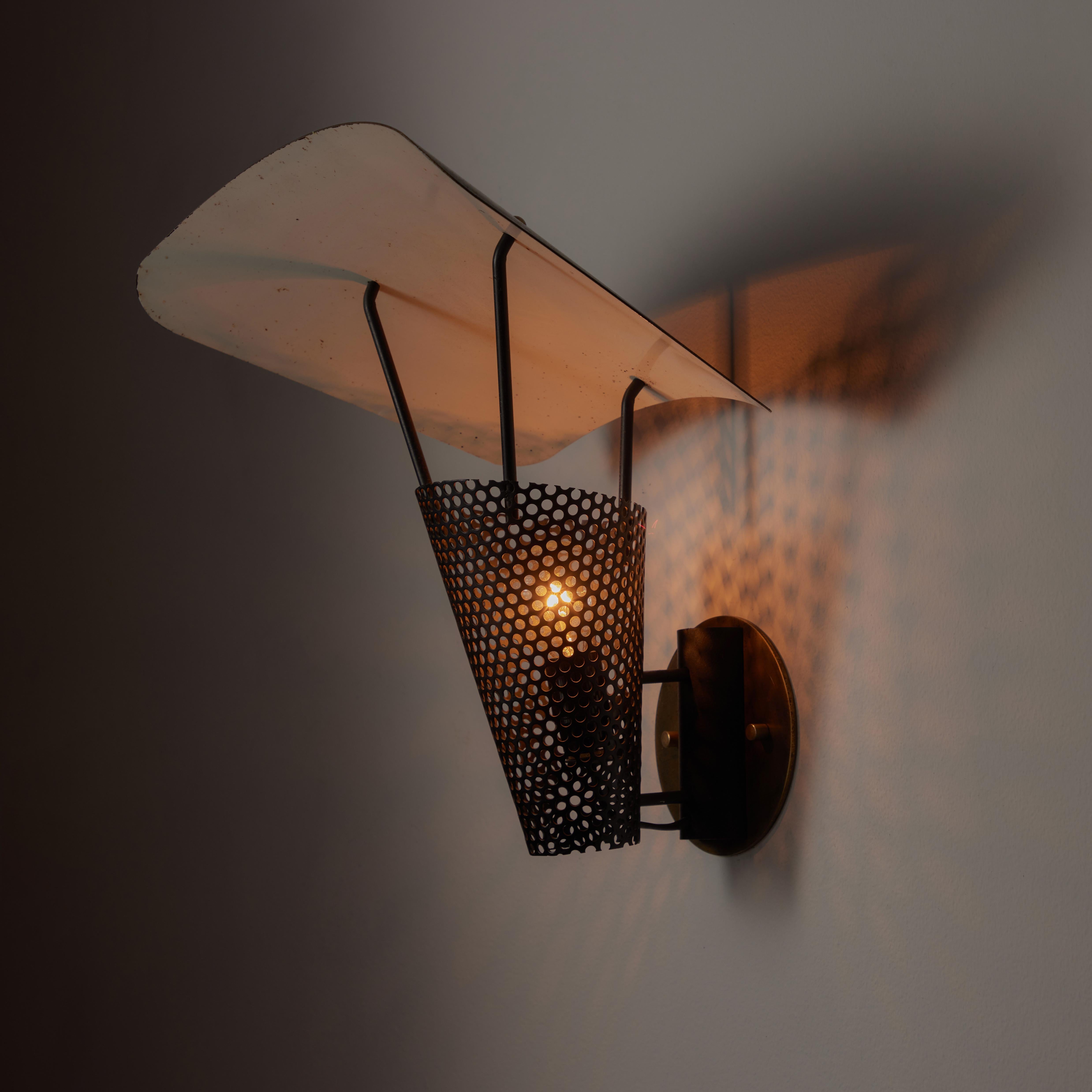 Single 'Cerf-Volant' sconce by Jacques Biny. Designed and manufactured in France, circa the 1950s. Perforated shade, with an enameled black and white reflector umbrella. Custom US backplate. Holds one E14 socket type. We recommend one 60w bulb. Bulb