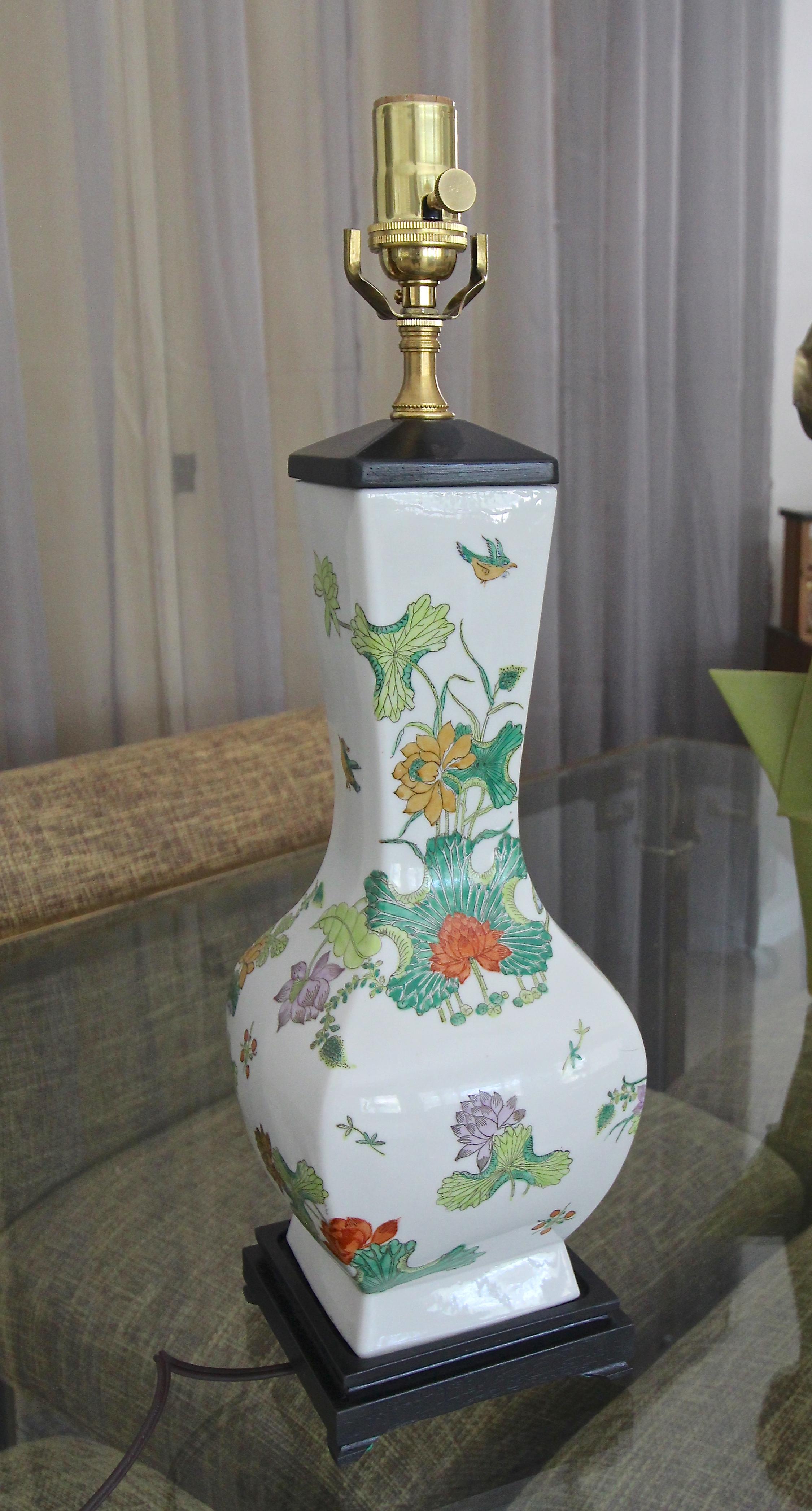 Single Chinese porcelain Famille rose vase mounted as table lamp on black painted wood turned base. Beautifully crafted with bright applied floral images. Newly wired including new brass fittings and 3-way socket.
Measures: Height to top of