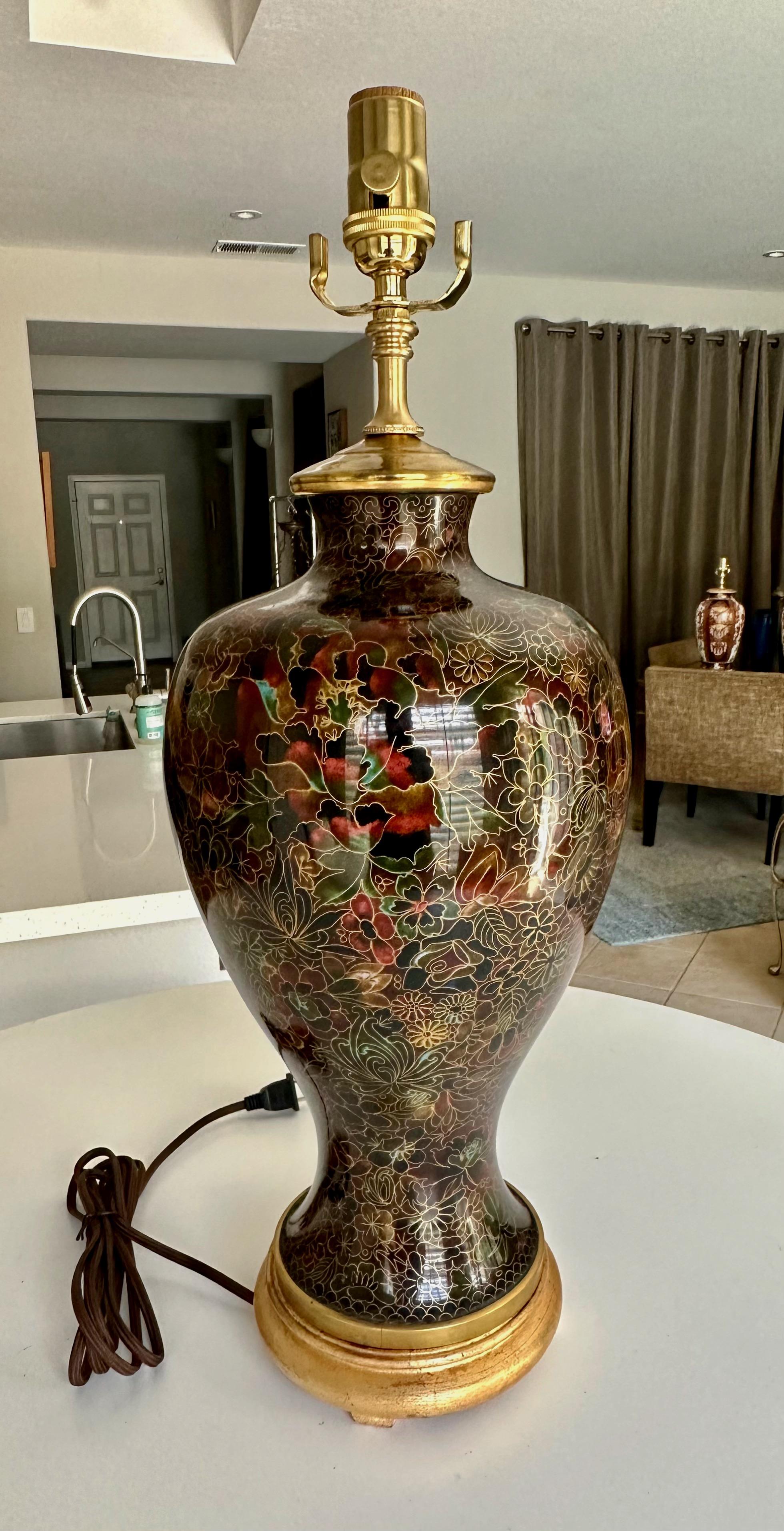 Single Chinese Cloisonné table lamp mounted mounted on giltwood base. Nicely designed with black floral motif with hints of green and red. Rewired with new 3-way socket and rayon cord. 
Shade not included.
