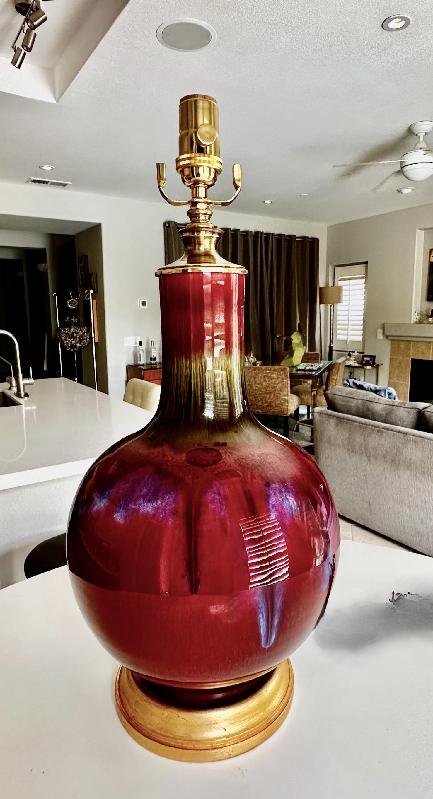 Single Chinese Asian Sang de Boeuf oxblood porcelain vase mounted on gilt turned wood lamp base by. Rewired with new 3 way brass socket and cord.
Measures: Height top of socket 21