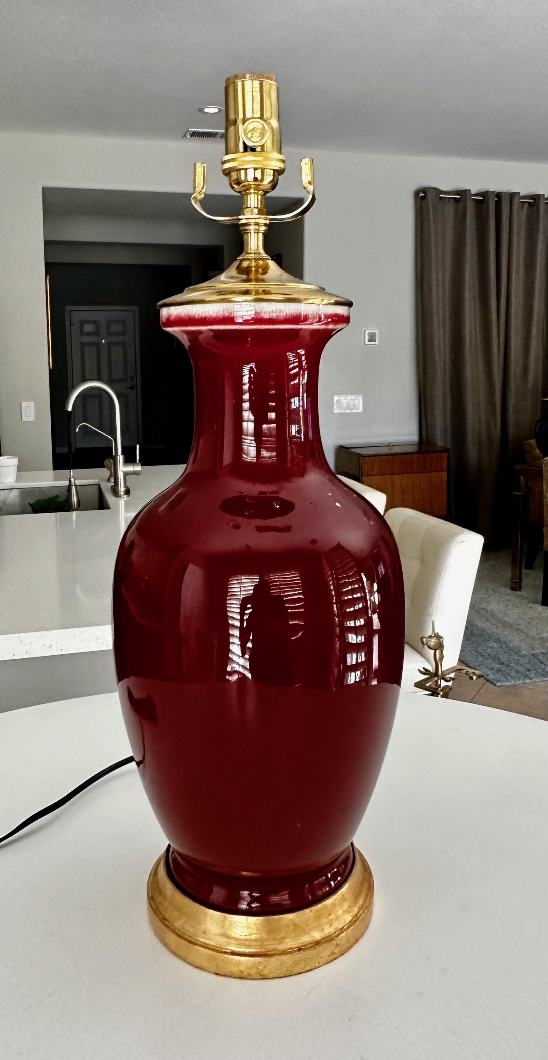 Single Chinese Asian Sang de Boeuf oxblood porcelain vase mounted on gilt turned wood lamp base by. Rewired with new 3 way brass socket and cord.
Measures: Height top of socket 20.5