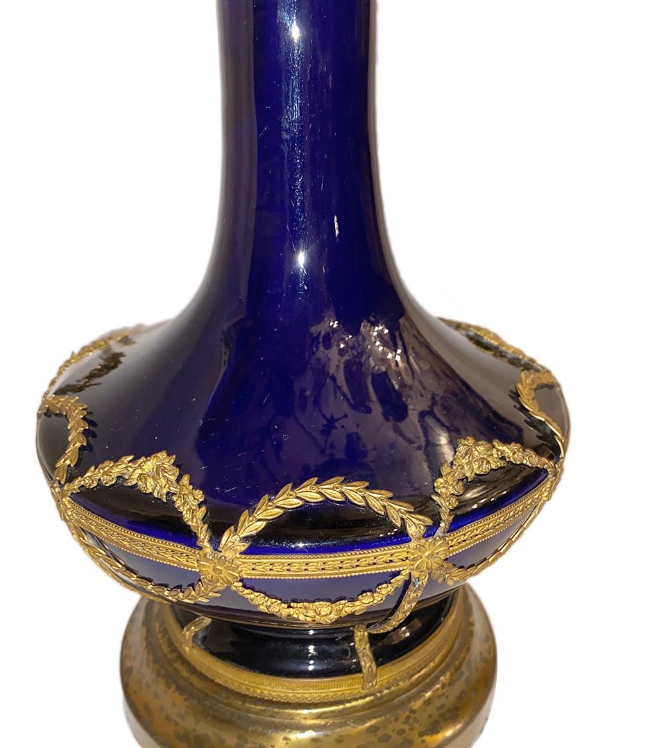 A single turn-of-the-century French cobalt blue porcelain table lamp with applied gilt details.

Measurements:
Height of body 12.5