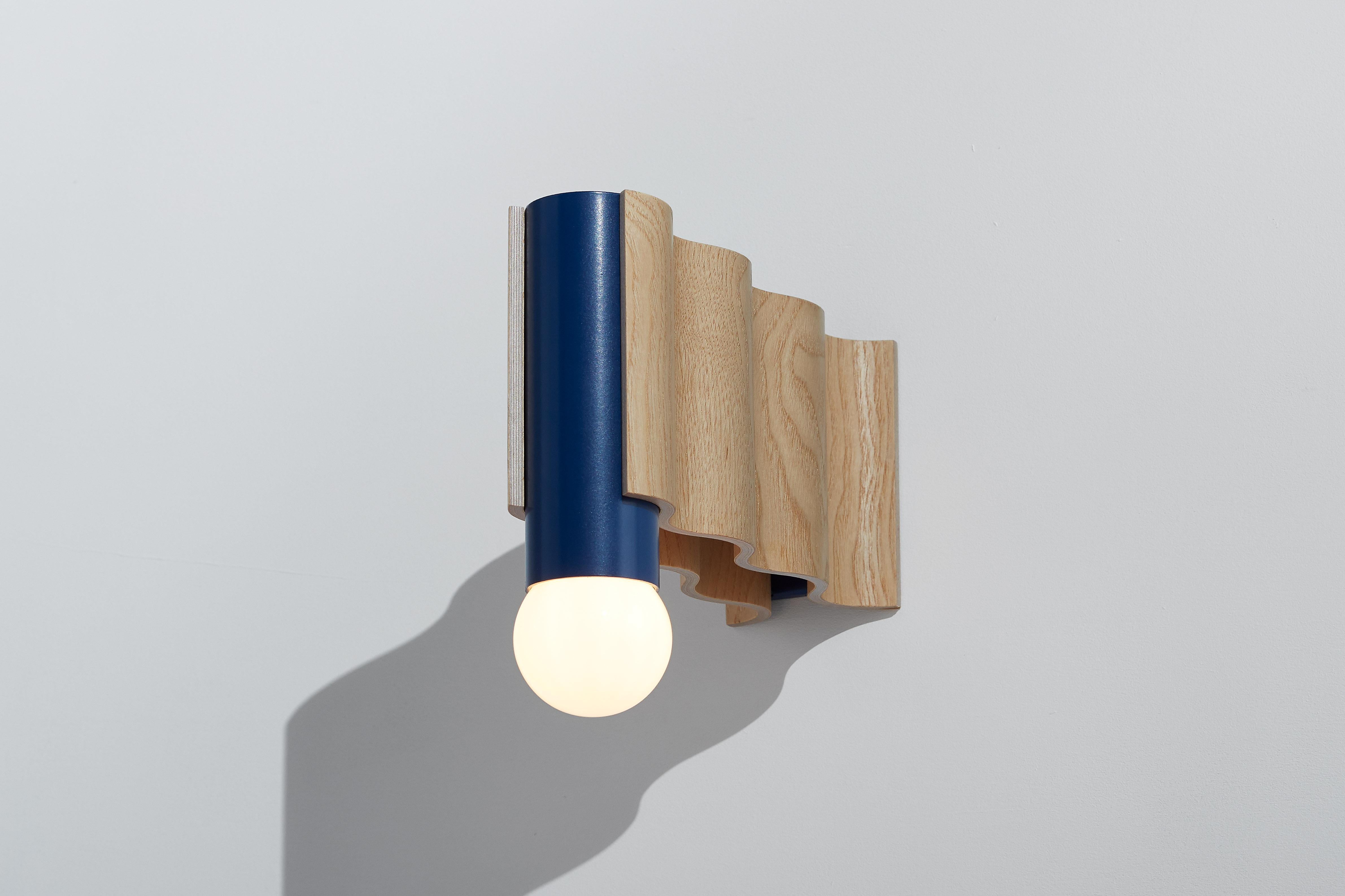 Single sconce made from natural ash veneered plywood (clear coated) and sapphire blue powder-coated aluminium tube.

Technical information:
- Comes with dimmable bulb (Class A60, 8W, 720 Lumen, 3000° Kelvin, A+ energy rating, Ra > 80)
- Can be wired