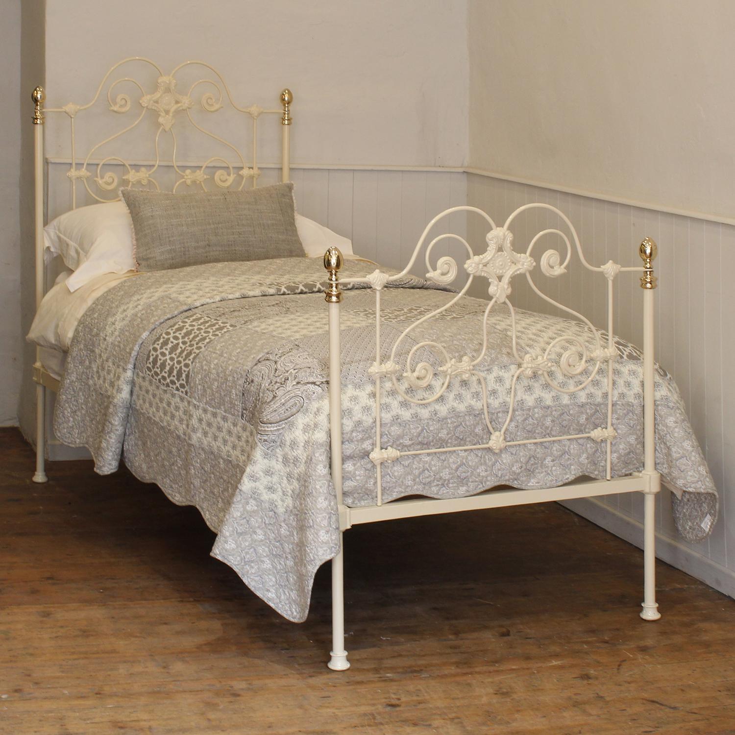 A highly ornate cast iron single bed from the height of the Victorian era finished in cream with oval knobs.
This bed takes a standard UK single 3ft wide x 6ft 3in long base and mattress, but will take a US twin 38 inch wide base and mattress with a