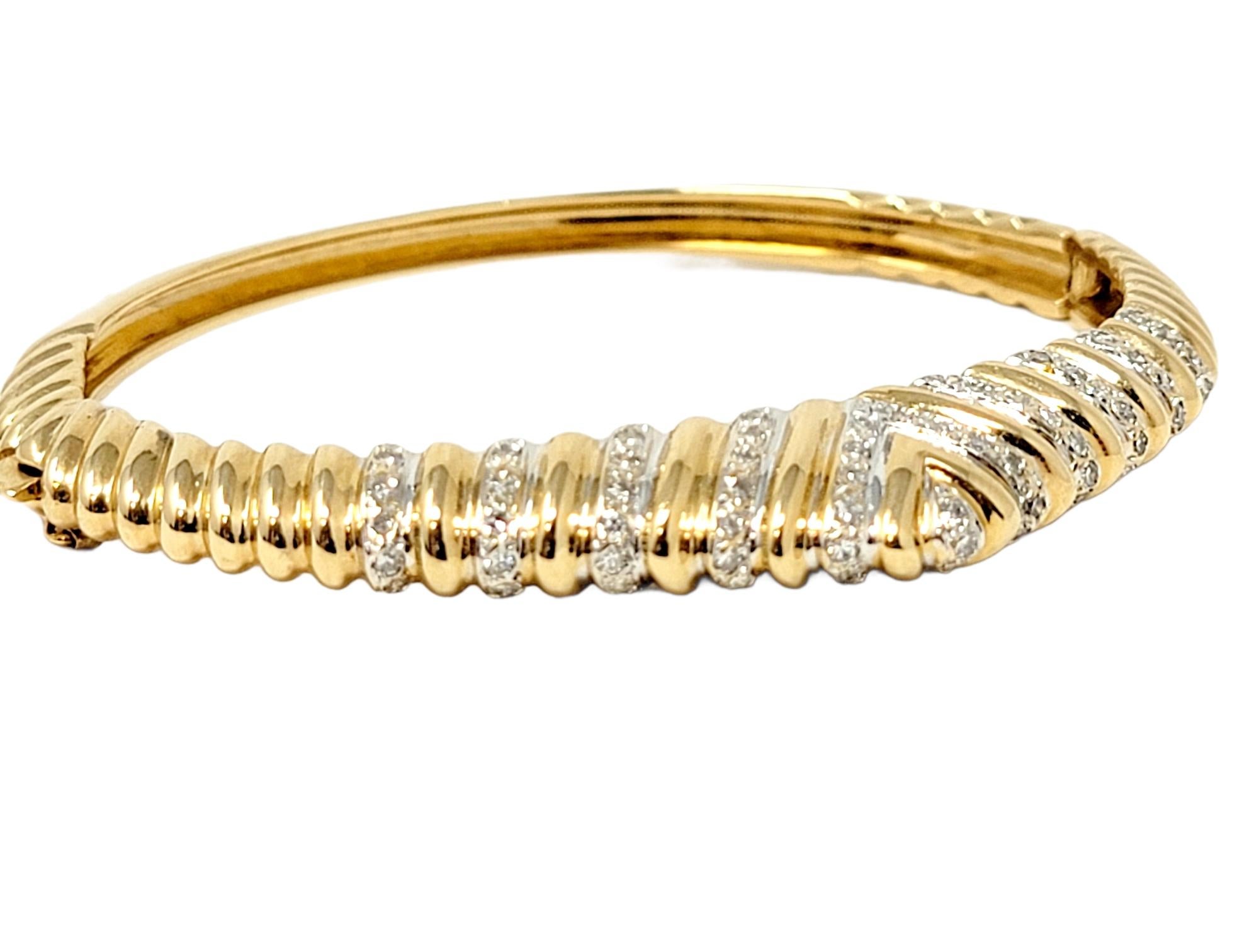 Beautifully designed, elegant bangle bracelet with an angled dome top. Featuring glittering diamonds and a contemporary ribbed chevron design, this lovely piece will make a wonderful additional to your jewelry wardrobe. Sparkling natural diamonds