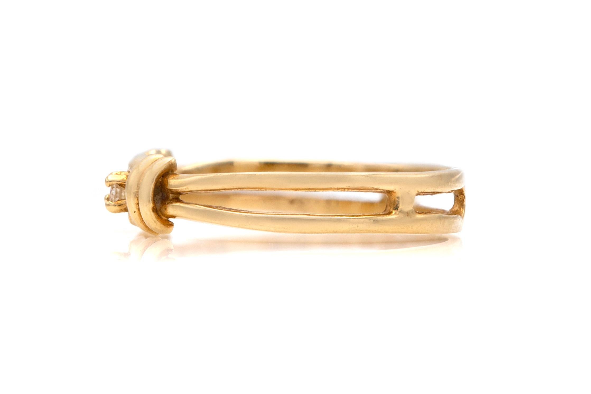 Finely crafted in 14K yellow gold with a diamond center stone weighing approximately 0.05 carat.
