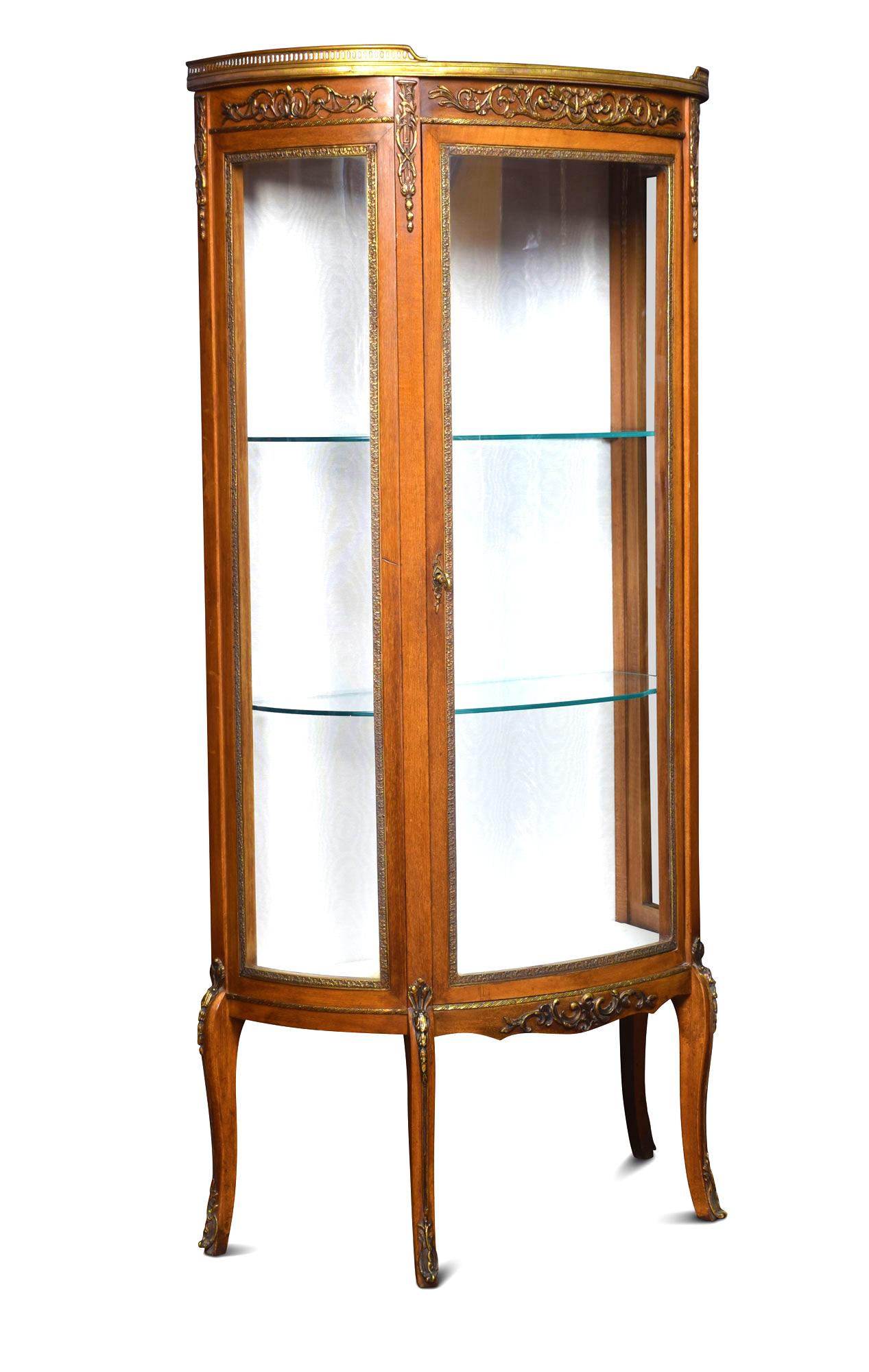 Walnut display cabinet, the marble top with raised three quarter ormolu gallery Above glass sides and bow fronted door enclosing two glazed shelves, all raised on elegantly curved legs with ormolu sabots.
Dimensions:
Height 55 inches
Width 26