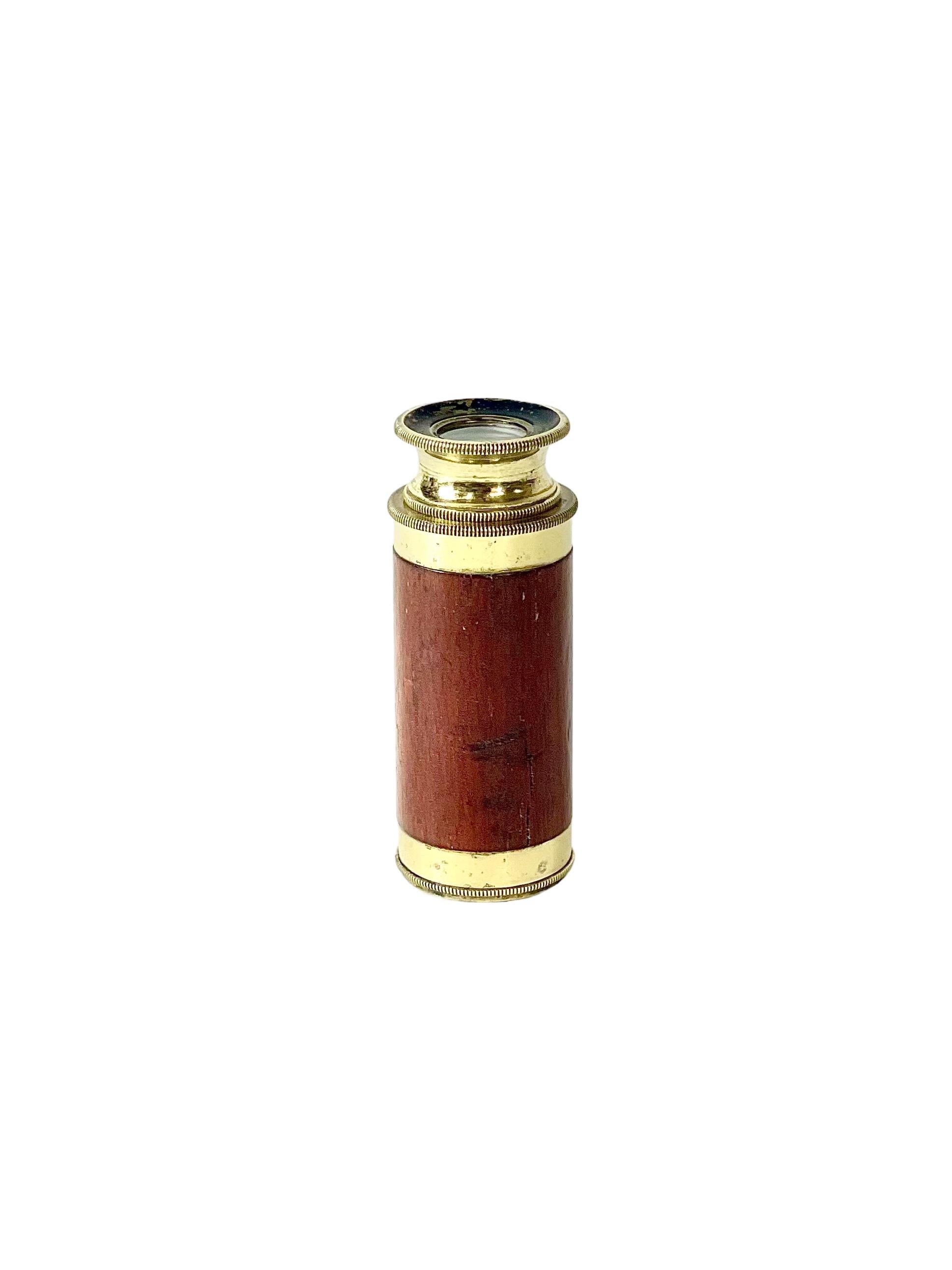 An antique French single draw telescope. Petite in size, its main barrel is covered with wonderful dark, veneer fruit wood, while the fixings and sliding drawer are gleaming brass. Designed to be hand-held, it is likely that this beautiful spy glass