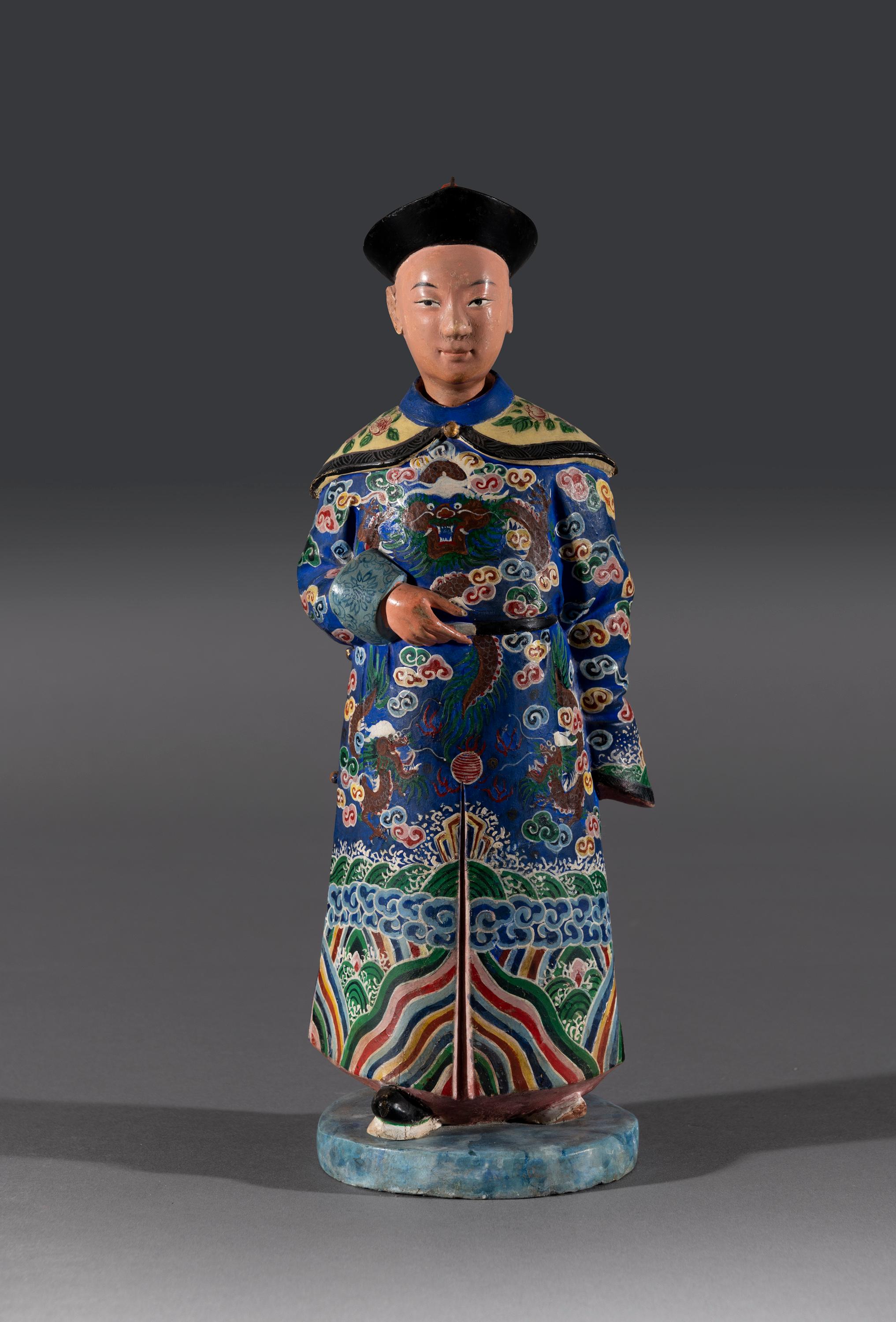 The clay figure of a Chinese man with nodding head in traditional dress from the 18th and 19th Centuries is beautifully hand painted and still retains the original colors and finish. Figurines such as this are rare and often referred to as ‘Chinese