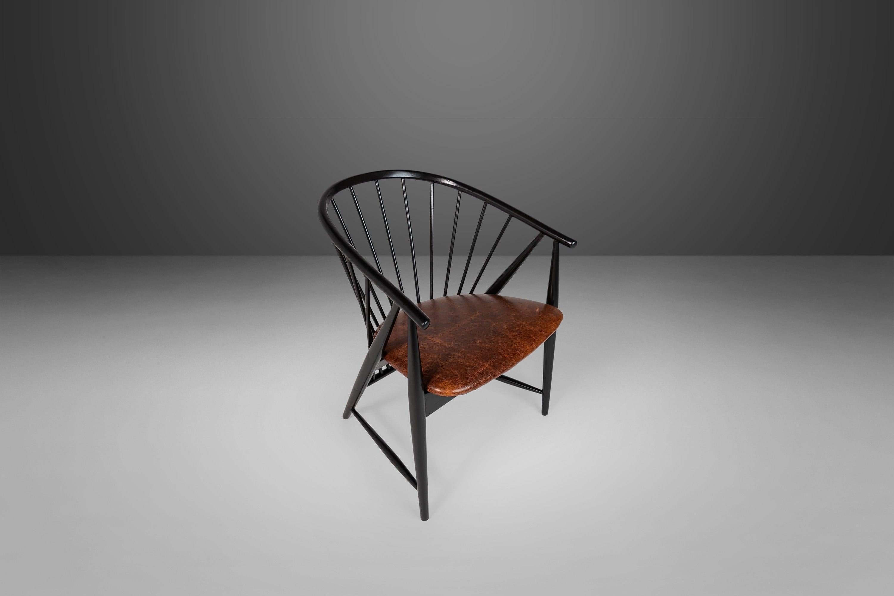 A spindle back design by Sonna Rosen of Sweden. Finished in ebonized beech wood. The seat has a distressed cognac leather seat with perfect patina.

---Dimensions---

width: 27.75 in / 70.49 cm
depth: 24 in / 60.96 cm
height: 29.5 in / 74.93