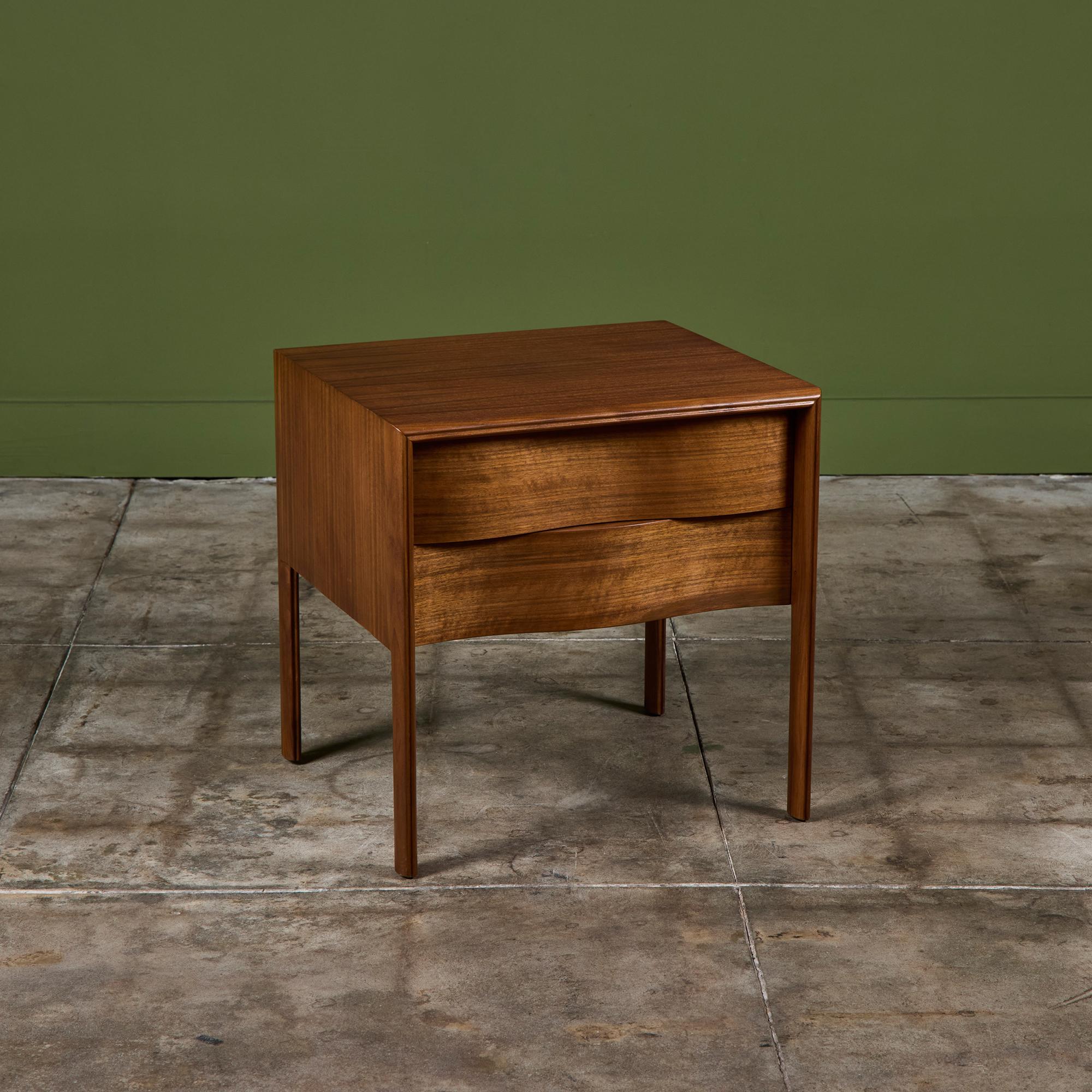 Single nightstand by Edmond Spence, c.1950s, Sweden. The walnut nightstand features two drawers with a unique sculpted wave front design. The stand rests on four splayed legs.

Dimensions
22