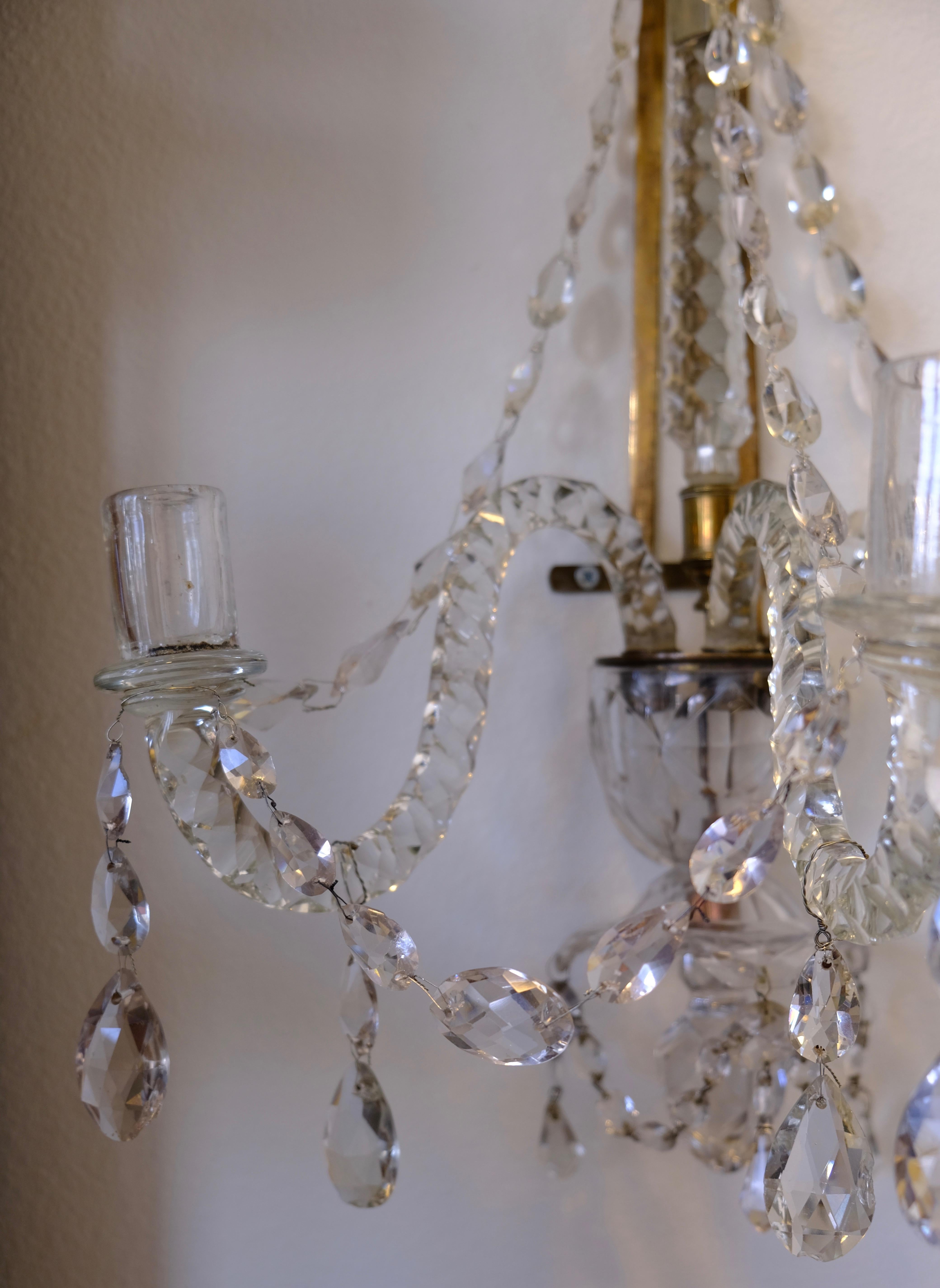 A charming crystal wall-light made in the 18th c. Originally it was of course a pair but one got lost. However the quality and condition of the remaining is really good.
  