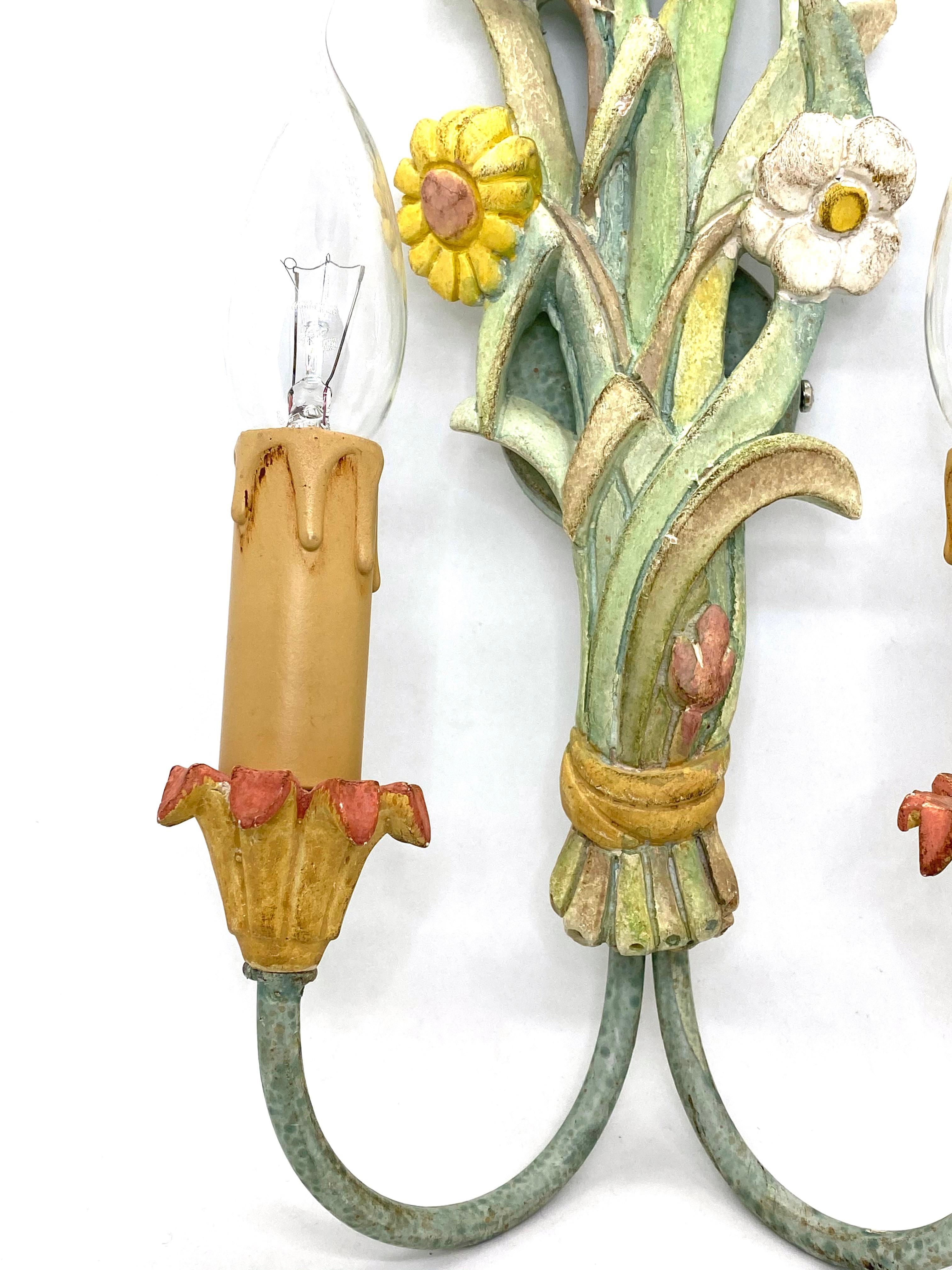 A single metal, stucco and wood floral sconce. The fixture requires two European E14 candelabra bulbs, each bulb up to 40 watts. The wall light has a beautiful color and gives each room an eclectic statement. Light bulbs are not included in this