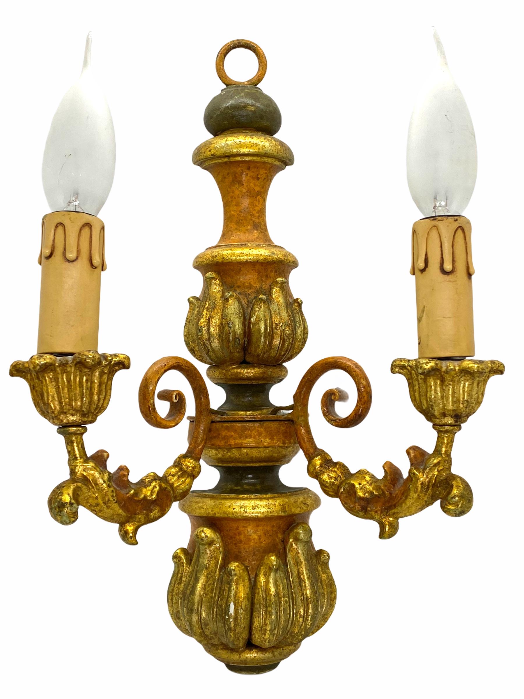 A single metal, stucco and wood sconce. The fixture requires two European E14 candelabra bulbs, each bulb up to 40 watts. The wall light has a beautiful color and gives each room an eclectic statement. Light bulbs are not included in this offer.