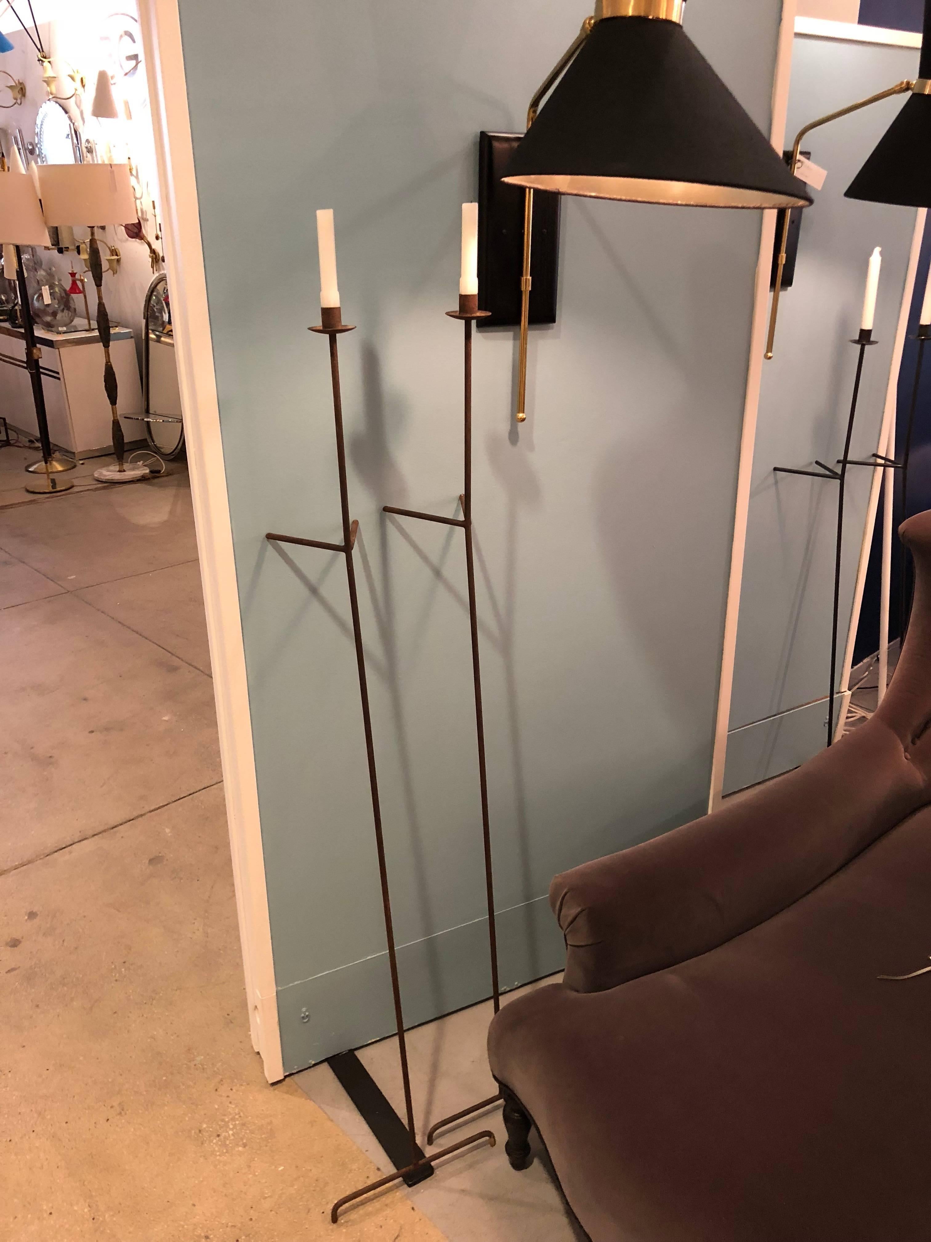 Single versatile candleholder. It leans against the wall and can be place almost everywhere to provide lighting. These candleholders are rusted steel and can go anywhere. They each use one taper candle each.