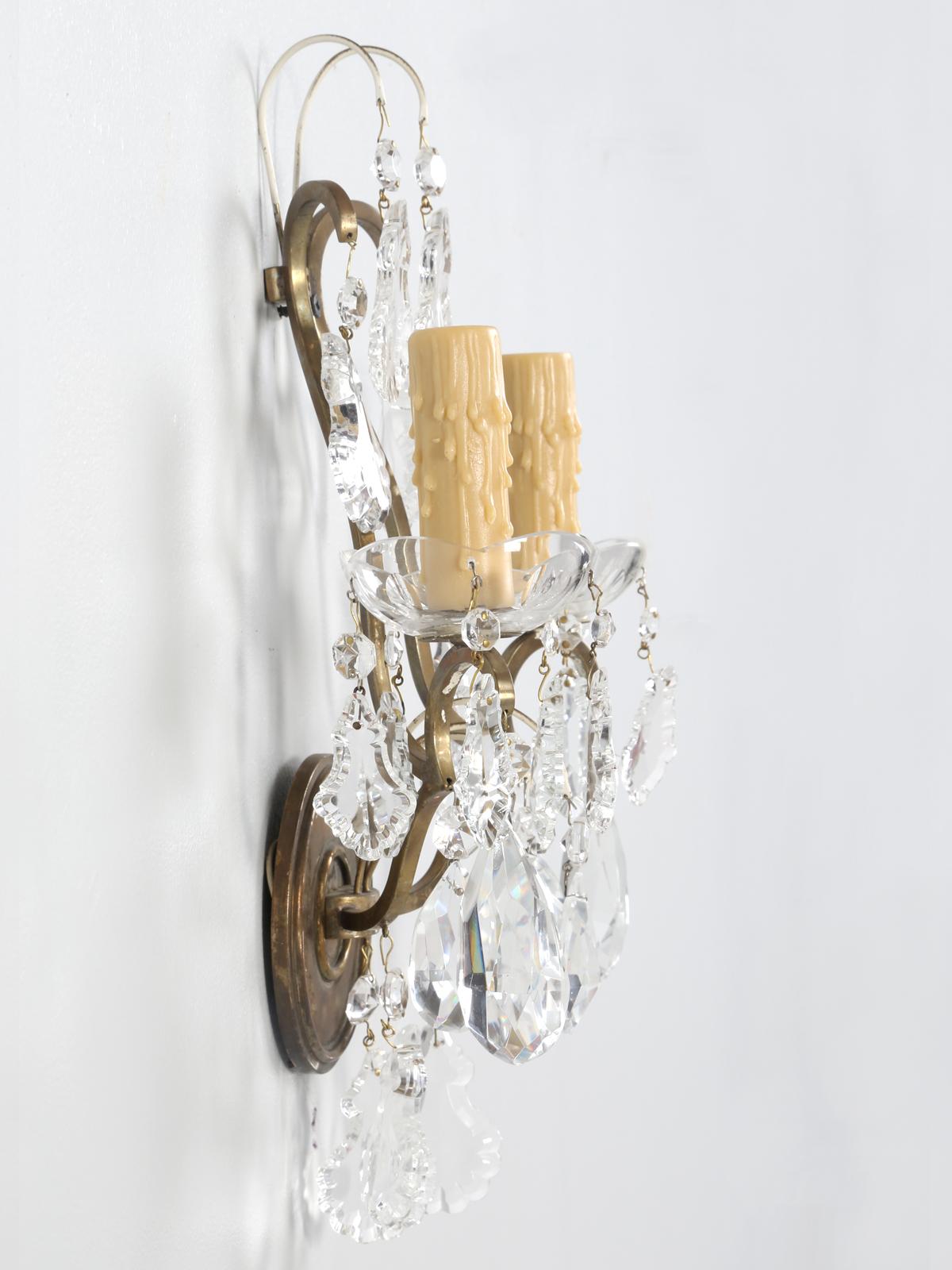 Single French brass and crystal sconce. The sconce is made from solid brass and not merely plated, as so many are and is quite heavy for something so small. The crystals are a blend of glass and crystal, which is not that unusual. Wired for the US