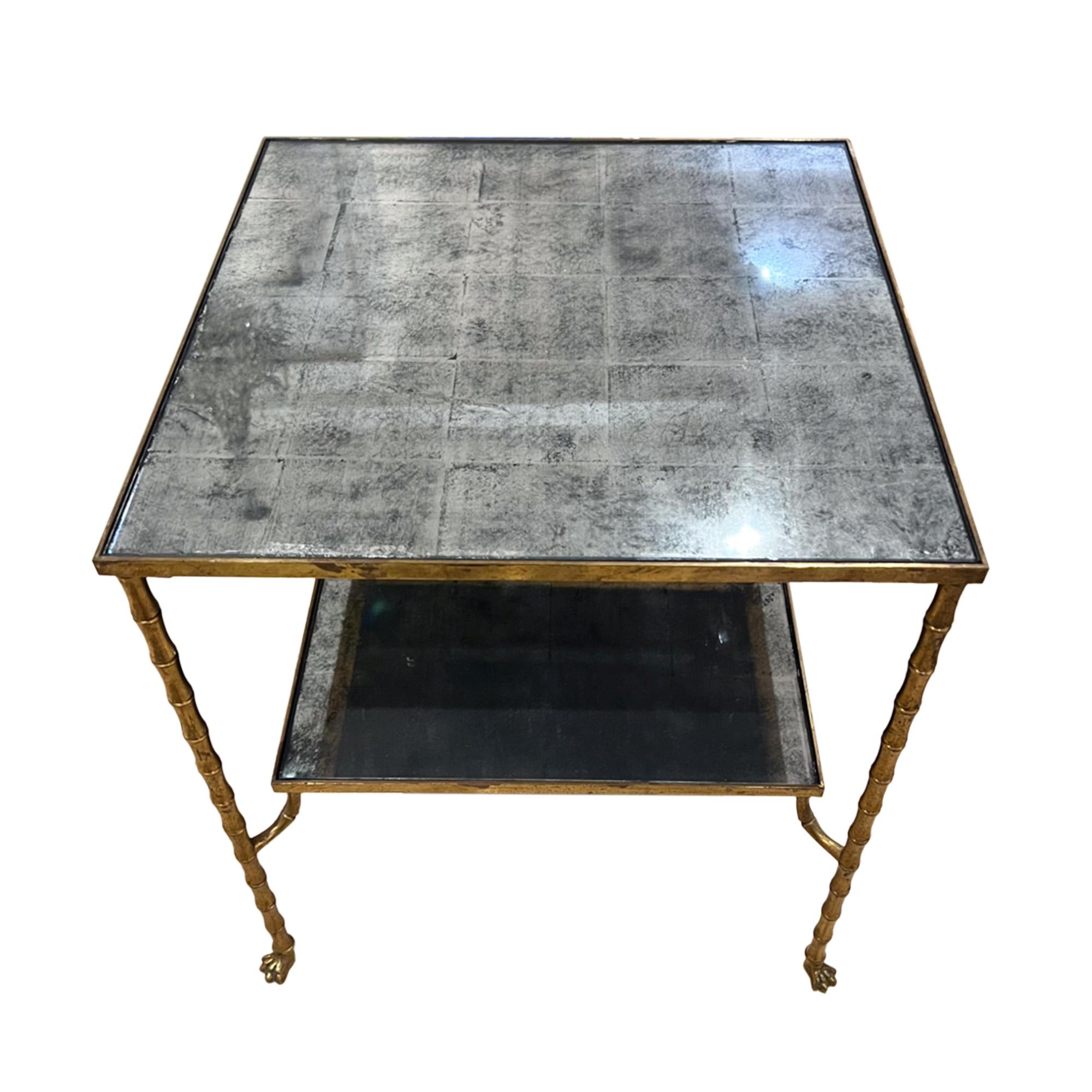 This is a lovely French midcentury side table, made from brass with a faux bamboo design with delightful paw feet. The eglomise glass on both shelves has a faint checked pattern - please take a look at all our photos to see the detail.

A good size
