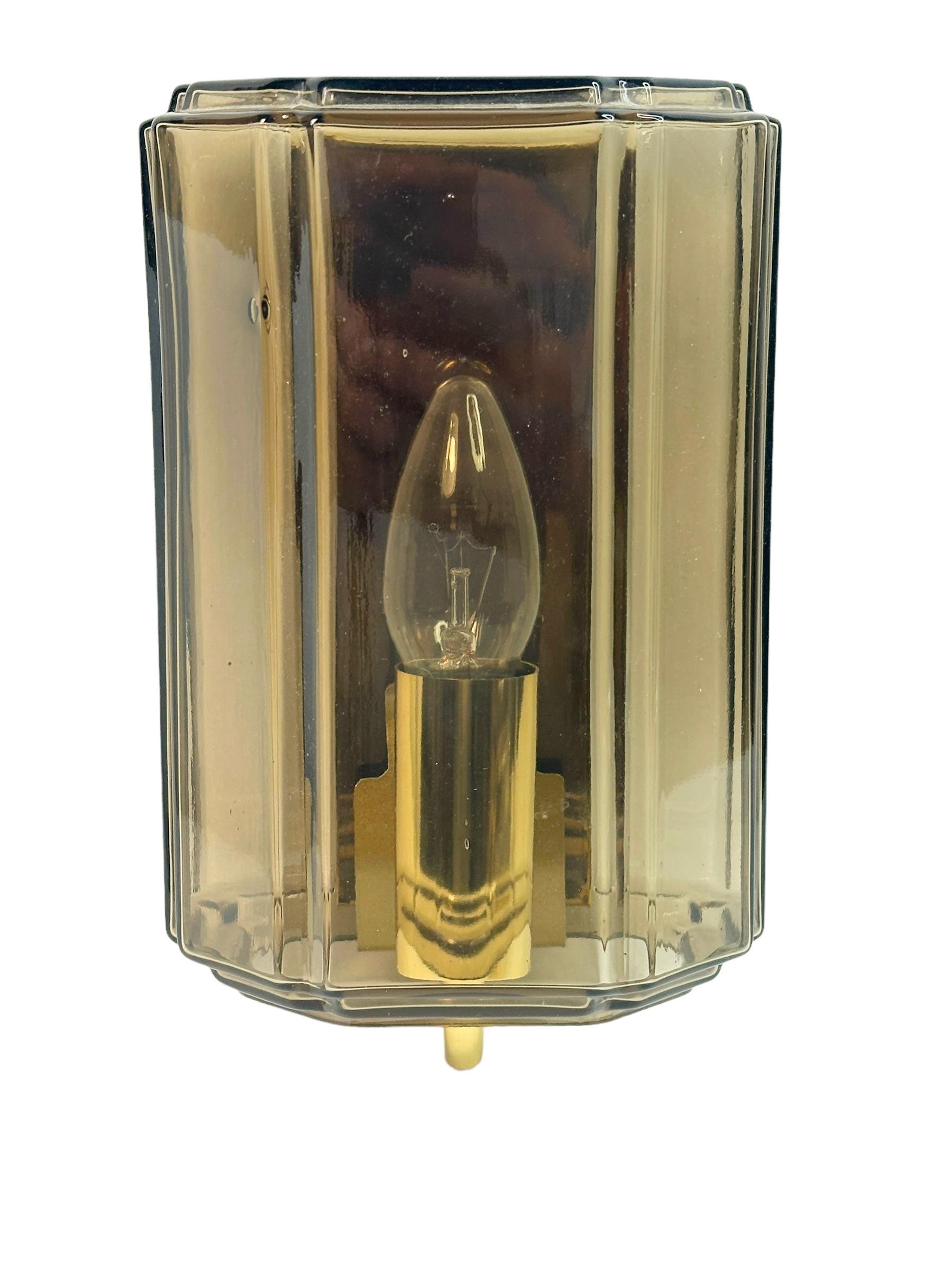 A beautiful and rare midcentury amber glass sconce designed for Glashuette Limburg (Germany, 1960s). The amber or champagne colored hand blown glass shade casts a wonderful light (see image). A Mid-Century Modern design Classic. Cleaned and ready to
