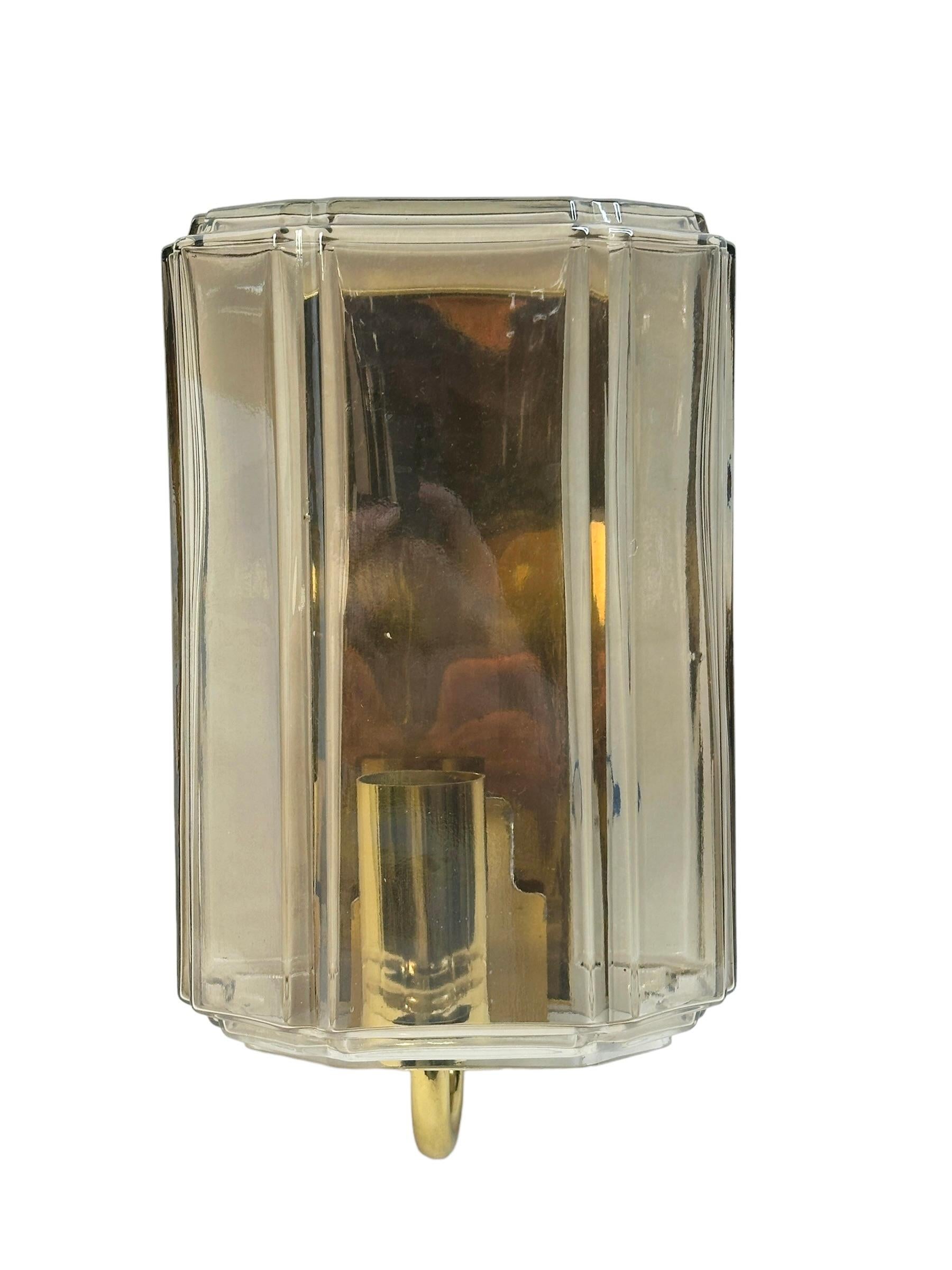 A beautiful and rare midcentury light clear smoked glass sconce designed for Glashuette Limburg (Germany, 1960s). The amber or champagne colored hand blown glass shade casts a wonderful light (see image). A Mid-Century Modern design Classic. Cleaned