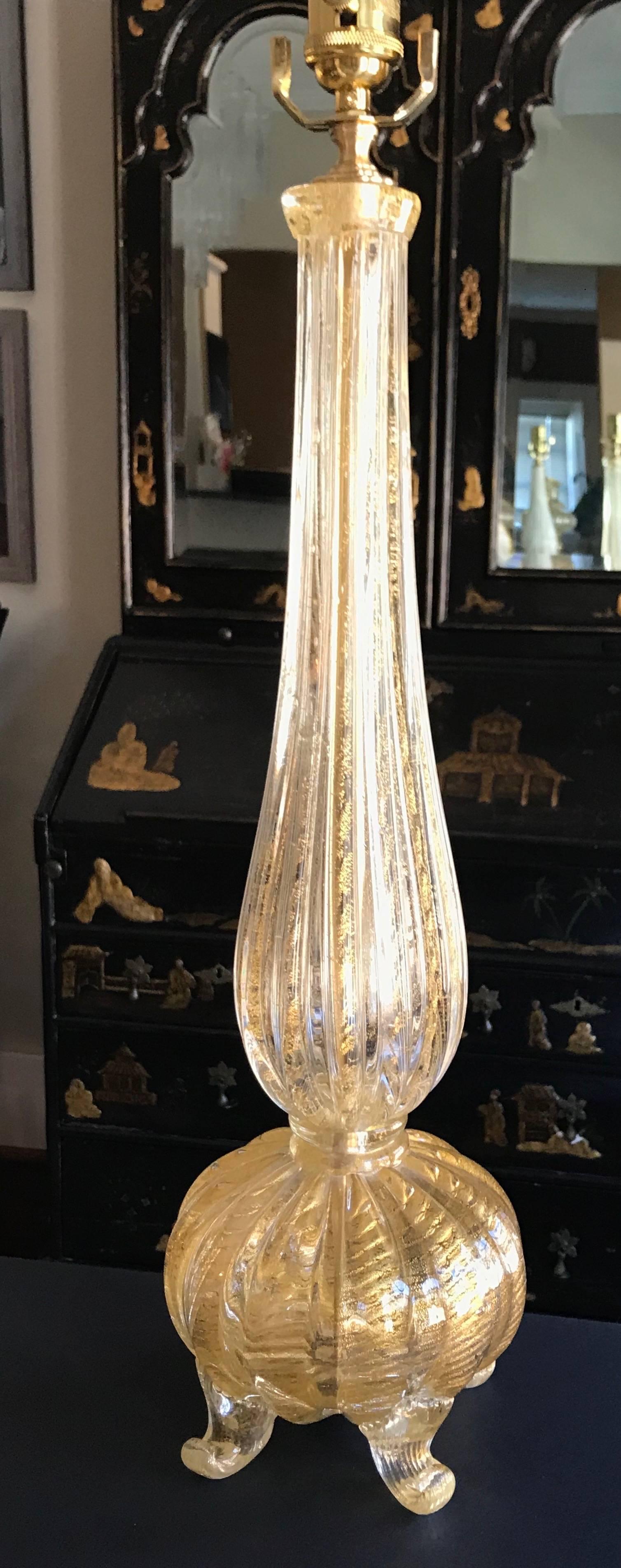 A single Italian Murano glass lamp in two parts with a footed base. This clear glass ribs with gold inclusions in the Coronado D'oro technique first developed by Barovier. Newly wired for US with full range dimmer socket, brass fittings and French