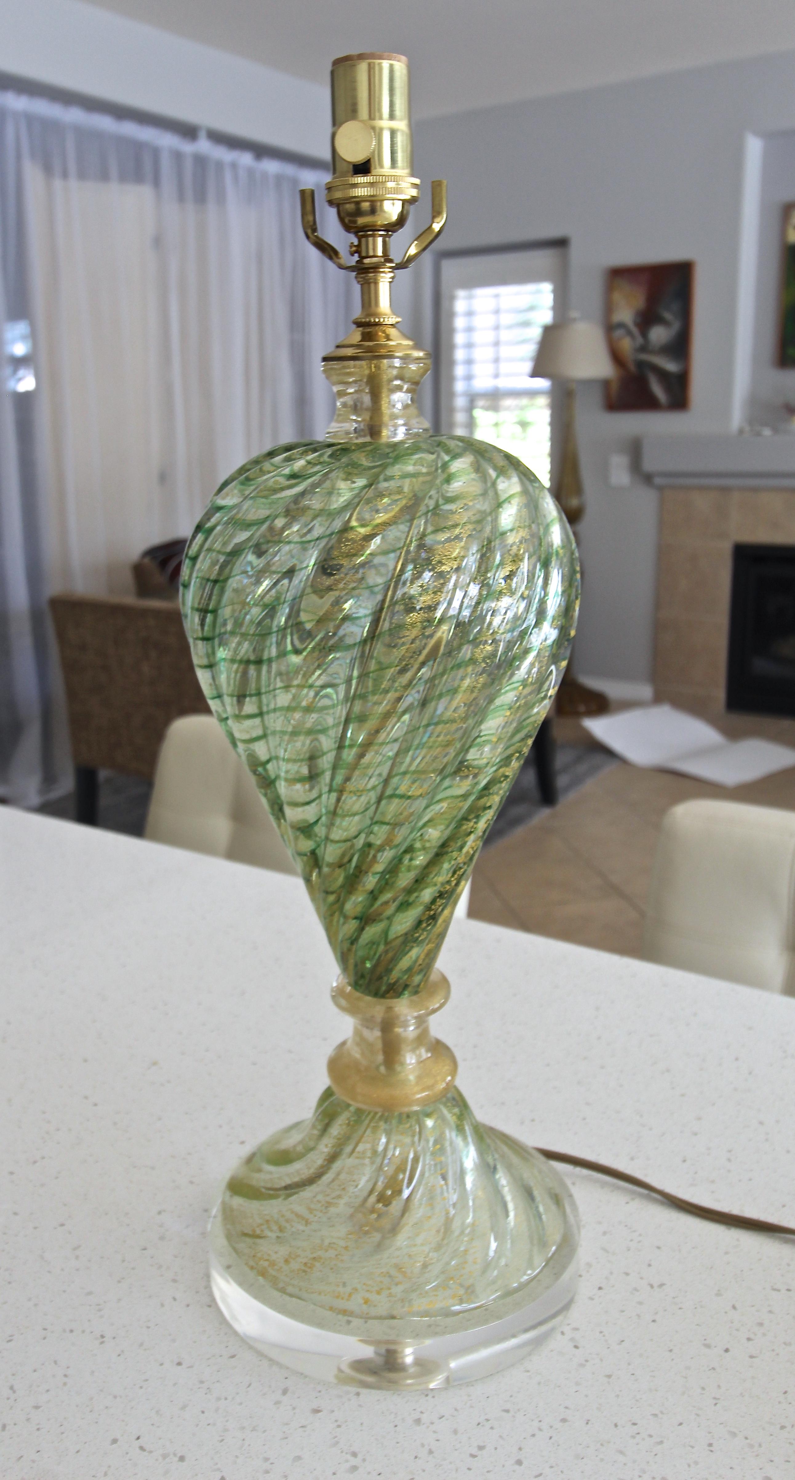 A single Italian Murano hand blown green glass with fine circular stripes and gold inclusions. Ribbed baluster form glass in 2 parts separated by 2 glass spacers. Newly wired with 3 way socket and cord, mounted on a new custom acrylic base.