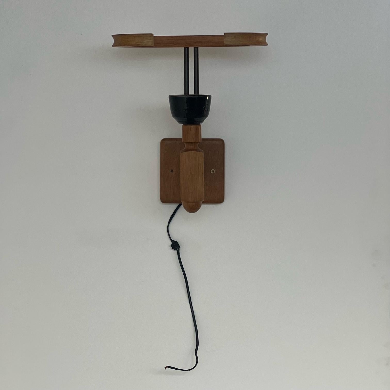 A single wall light in oak and ceramics. 

France, c1960s. 

By French designers Guillerme et Chambron. 

Since Re-wired and PAT Tested.

Internal ref: No.7

Location: Belgium Gallery. 

Dimensions: 36 H x 26 D x 31 W in cm.