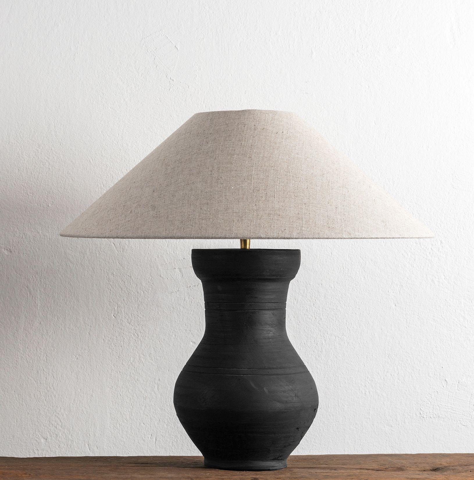 A beautiful unglazed Han dynasty style vase of a very elegant form.
Expectedly mounted as lamp - US WIRED. High quality mount with a brass adjustable pivot joint. 
The vase is from Zhejiang, china, mount and shade are made in Antwerp.
The Lamp is