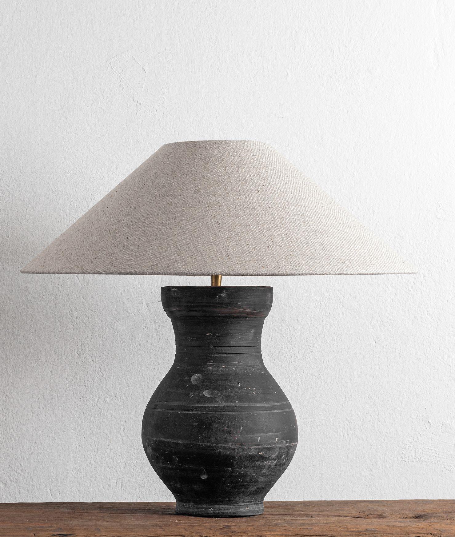 A beautiful unglazed Han dynasty style vase of a very elegant form.
Expectedly mounted as lamp - US WIRED. High quality mount with a brass adjustable pivot joint. 
The vase is from Zhejiang, china, mount and shade are made in Antwerp.
The Lamp is
