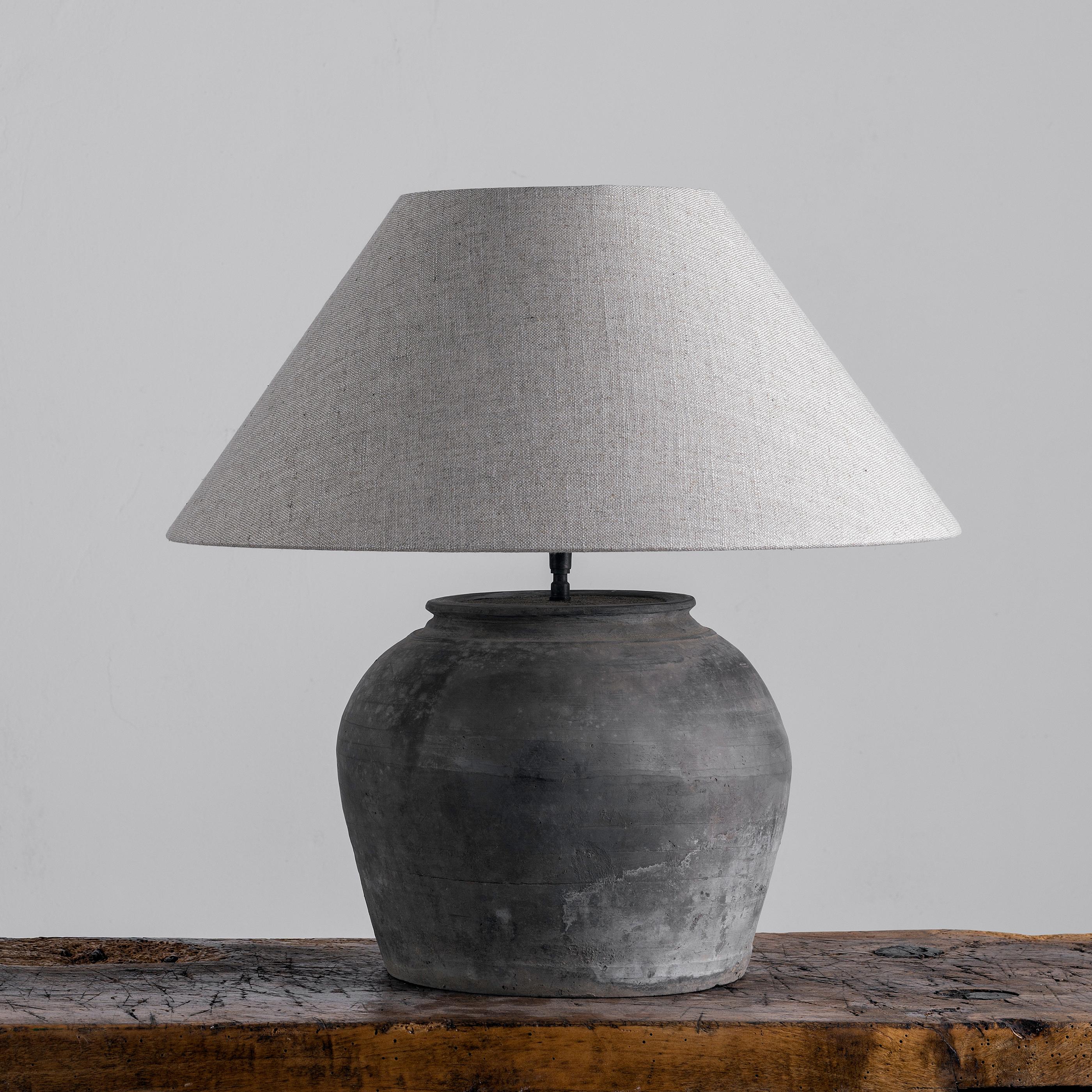 A beautiful unglazed Han dynasty style vase of a very elegant form.
Expectedly mounted as lamp - EU WIRED. High quality mount with a brass adjustable pivot joint. 
The vase is from Zhejiang, china, mount and shade are made in Antwerp.
The Lamp is