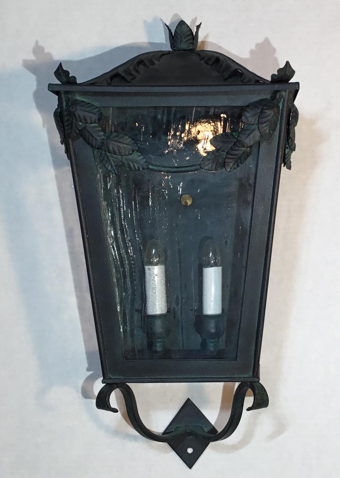 Decorative quality hand forged iron wall-mounted lantern, two 40/watt lights,
Clear artistic glass, beautiful vine decoration at the top and professional color finish, suitable for wet location.