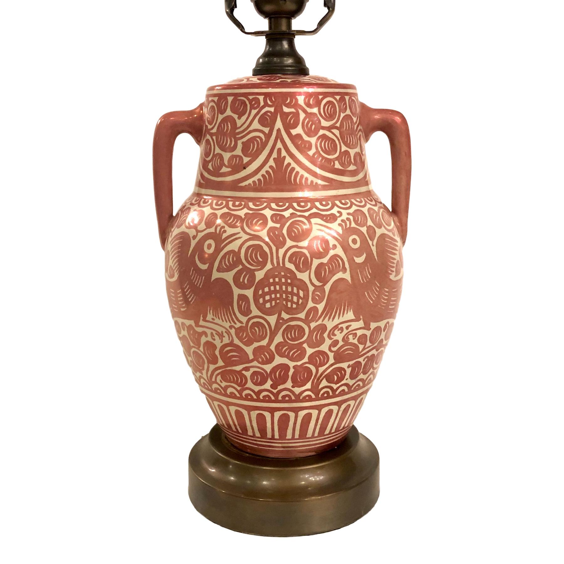 A single circa 1920's Italian hand-painted copper-glazed two-handled ceramic table lamp with foliage and bird motif.

Measurements:
Height of body: 11