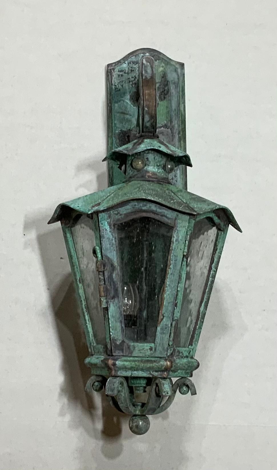 Quality artistic wall lantern handcrafted from bronze and brass in the three 40/watt lights up to US code suitable for wet location. Special quality light and I have only this one.